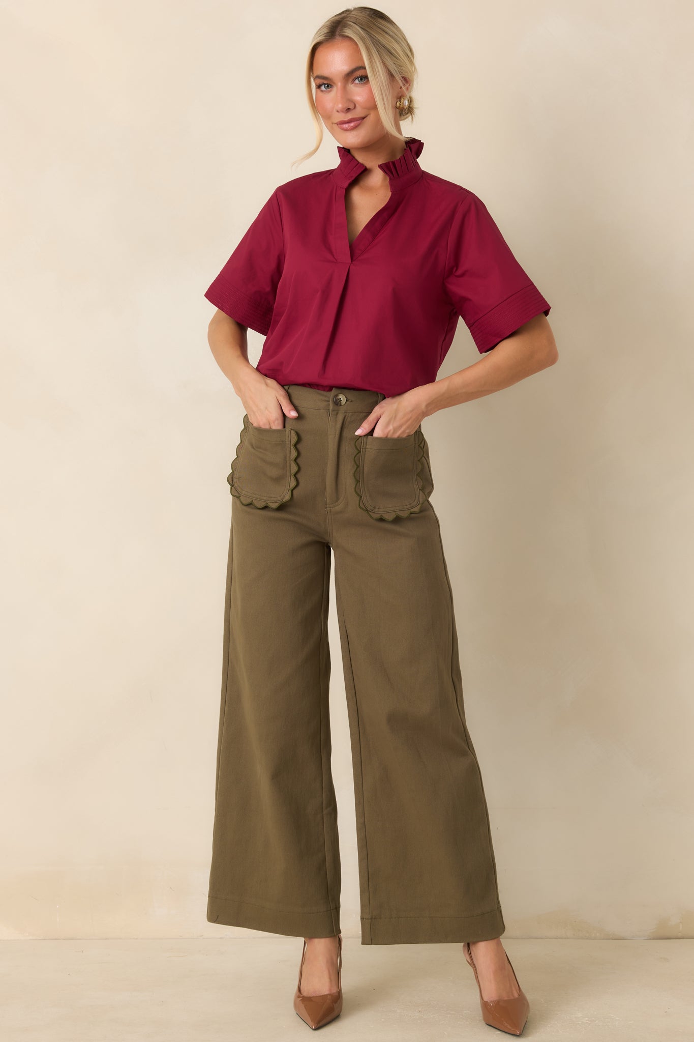 High-rise olive green pants featuring a relaxed wide leg silhouette, breathable woven cotton fabric, and refined tailoring for versatile everyday styling.