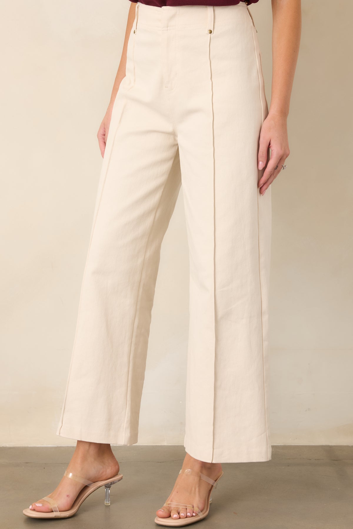 High-rise pant design showcasing the smooth cotton-blend fabric and polished pleated detailing.