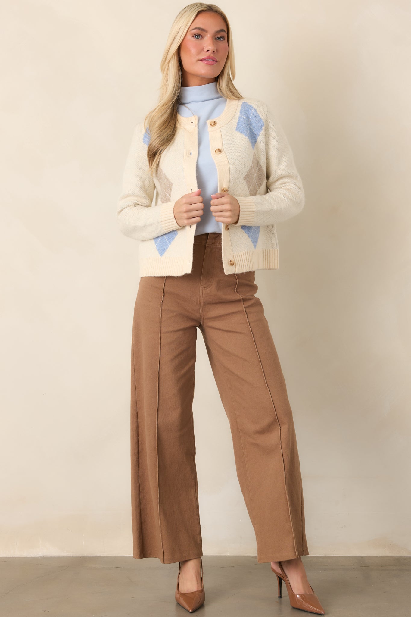 Cotton-blend pants featuring a flattering high-rise waist, sewn front pleats, belt loops, and a streamlined straight-leg silhouette.