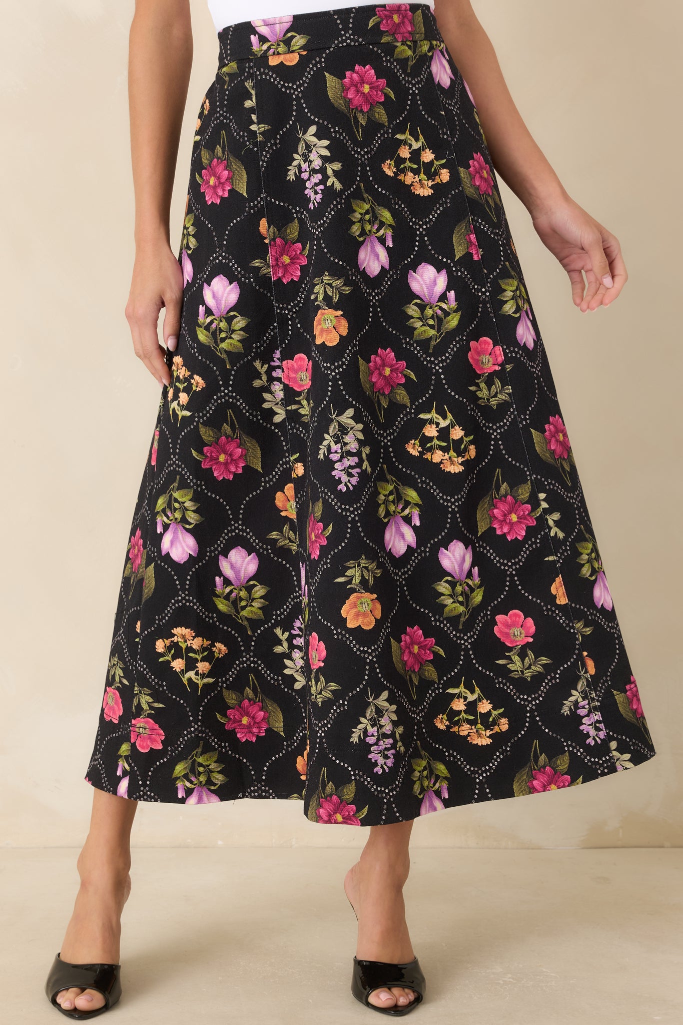 Colorful floral motifs stand out against the black base of this high-rise cotton-blend skirt.