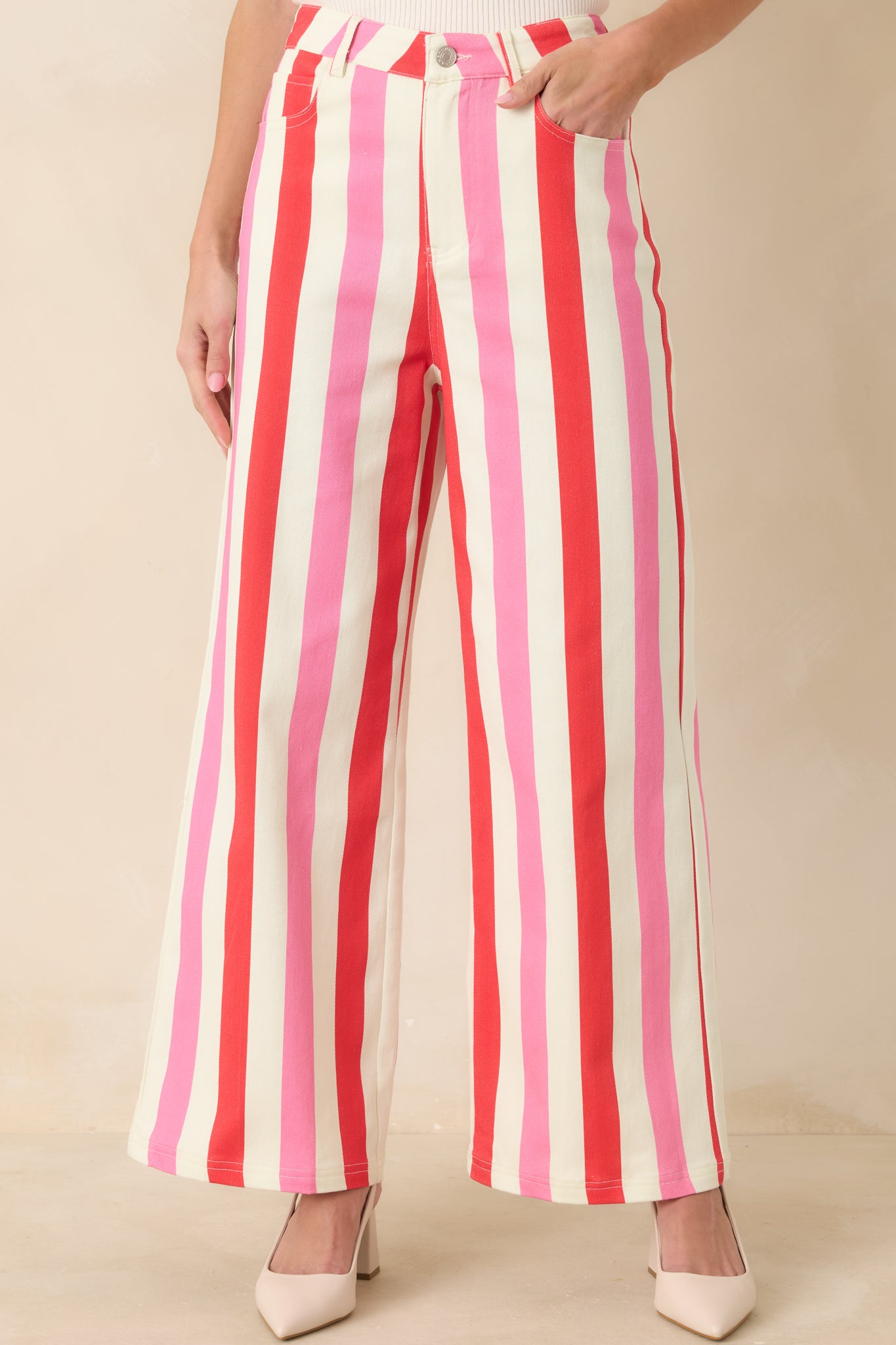Front view of the high-rise striped pants highlighting functional pockets and vertical stripe pattern.