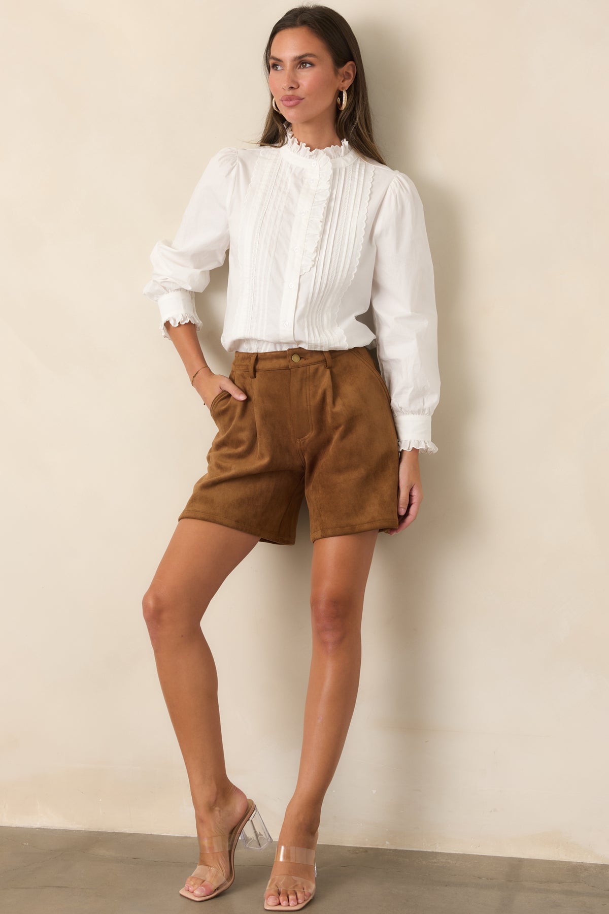 High-rise tailored shorts featuring belt loops, a gold-tone button, and relaxed legs.