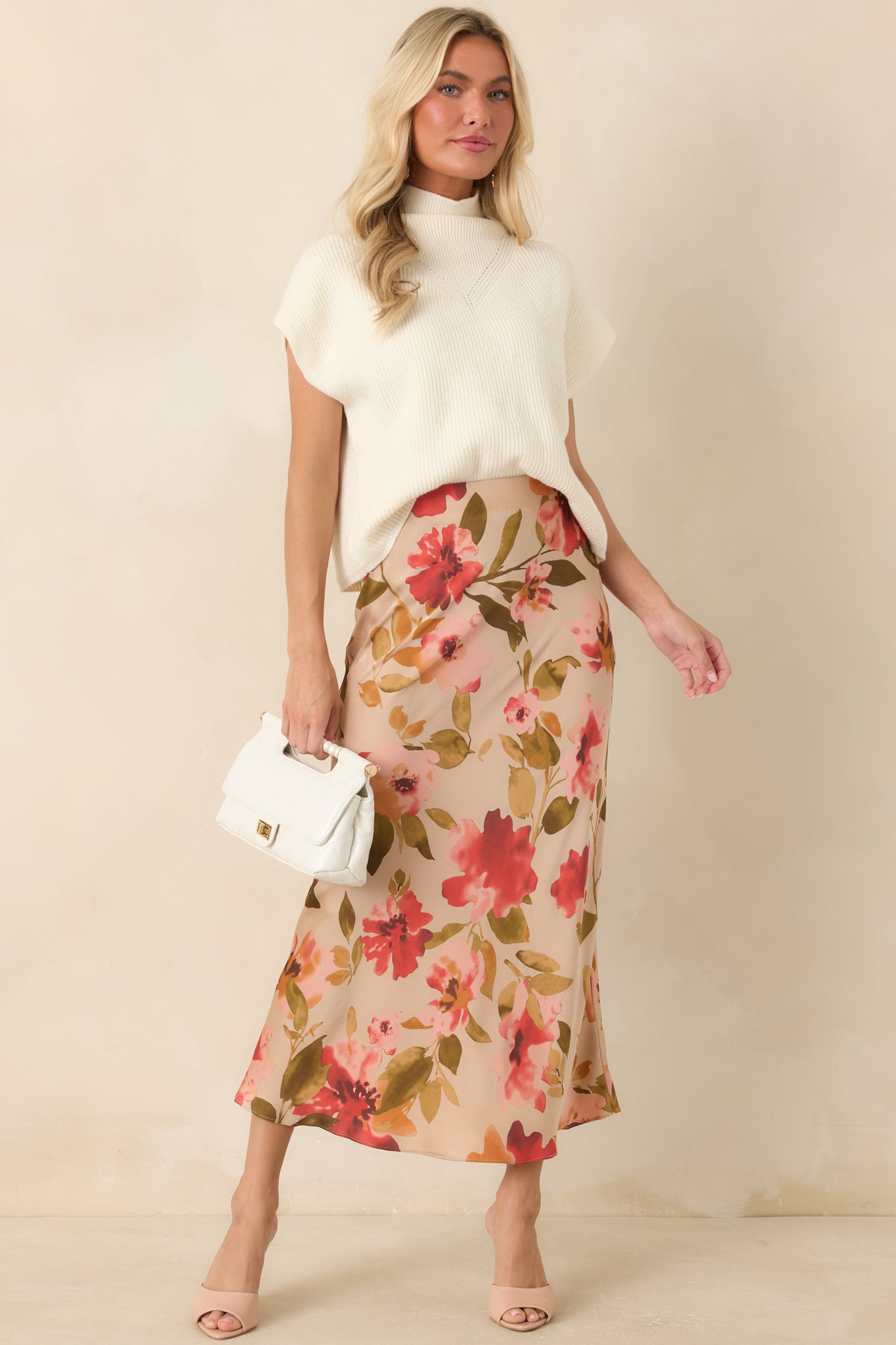 High-rise tan skirt showcasing a vibrant pink multicolor floral pattern and an elegant floor-length design.
