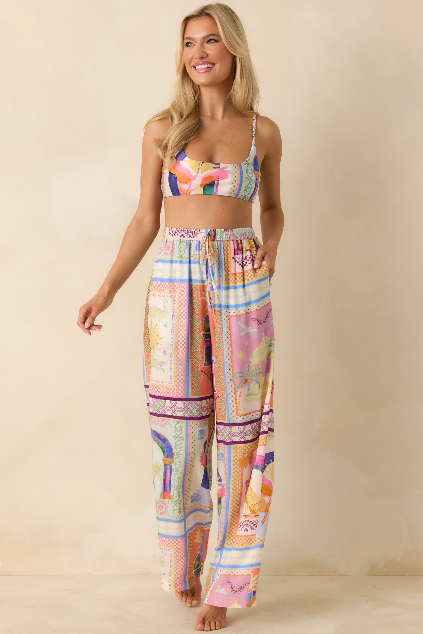 High-rise tropical print pants featuring a lightweight drape, elastic waistband, and wide leg flow.