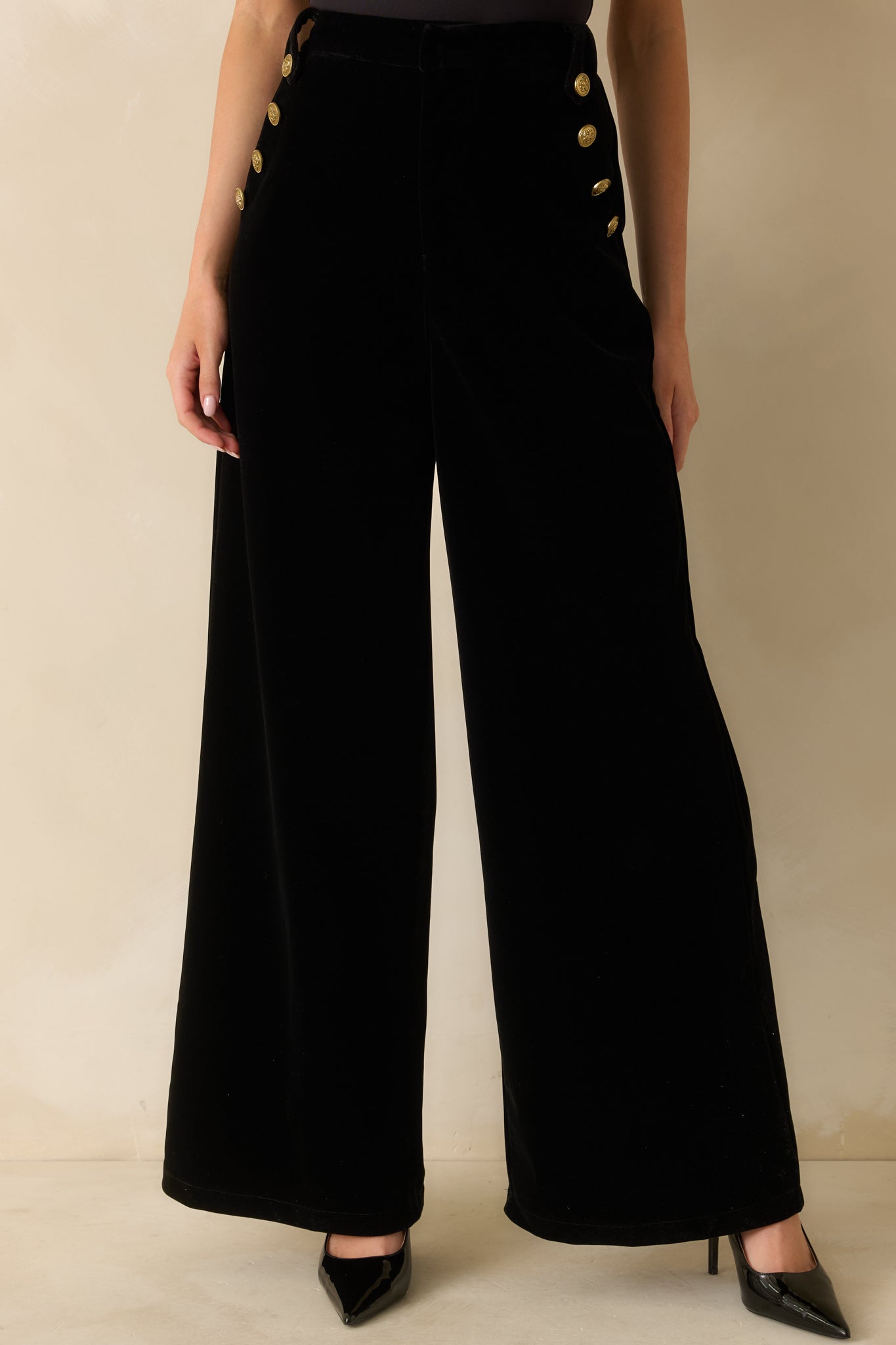 Close view of the high-rise waist and wide-leg shape showcasing the rich velvet fabric.