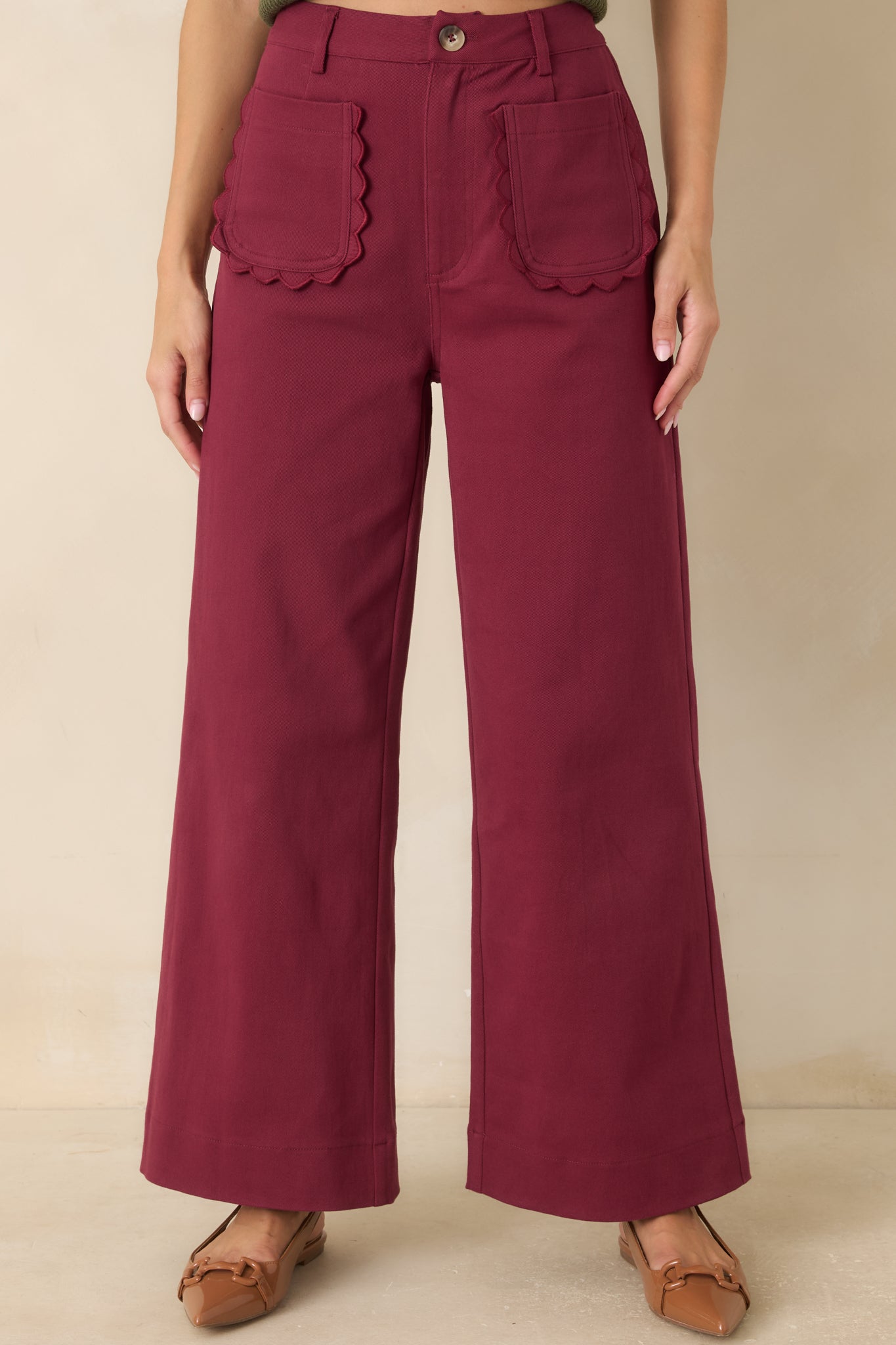 Close view of the high-rise waistband featuring belt loops, front closure, and structured tailoring details.
