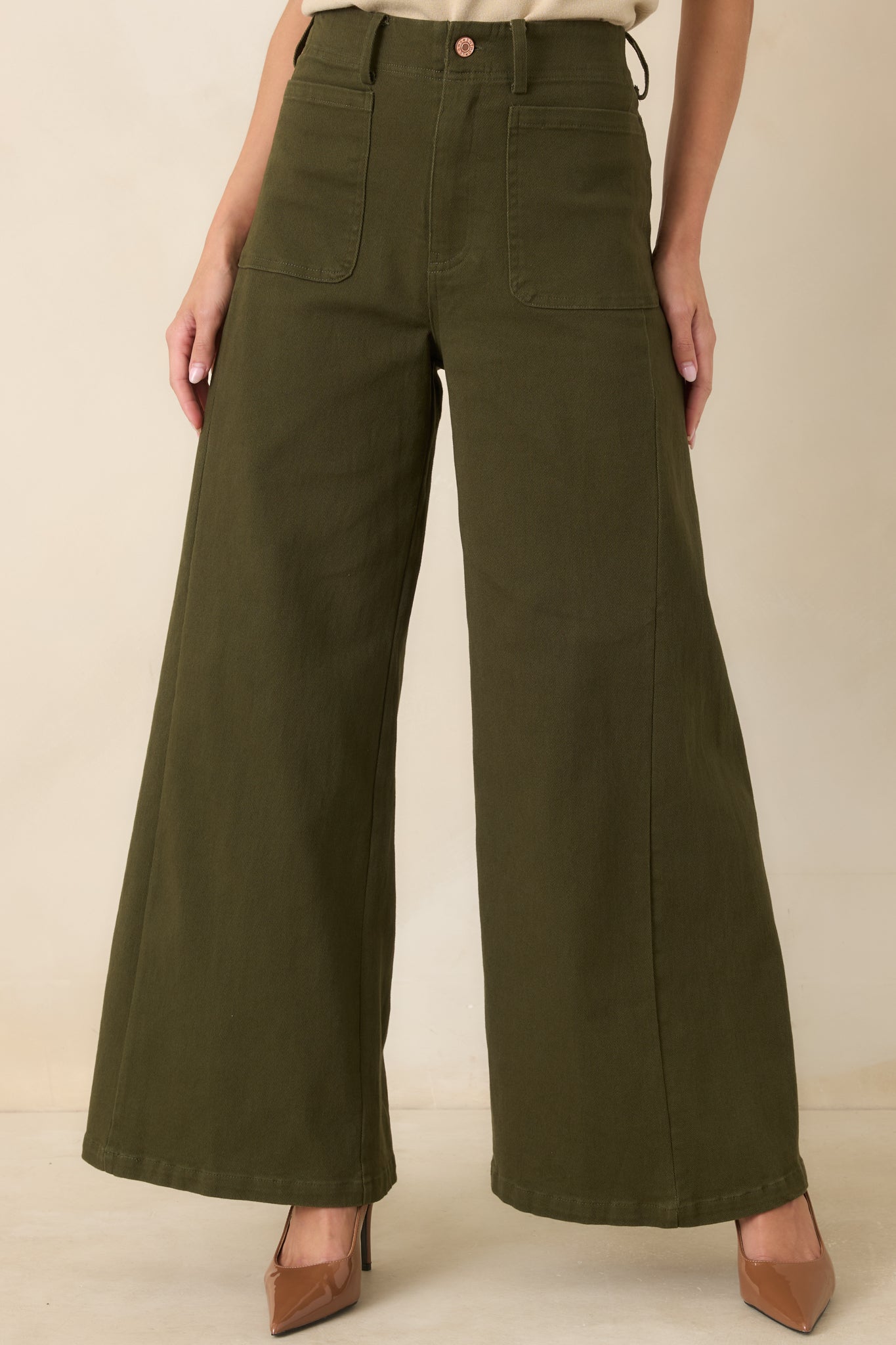 Detailed view of the high-rise waistband and front patch pockets on soft stretch cotton blend pants.