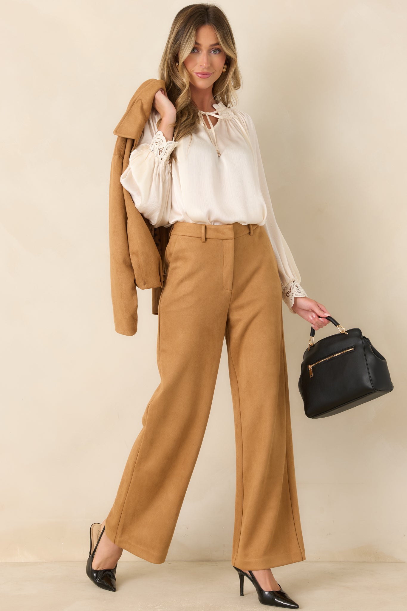 High-rise wide-leg pants featuring a structured front waistband, elasticized back waist, concealed front closure, and full-length silhouette.