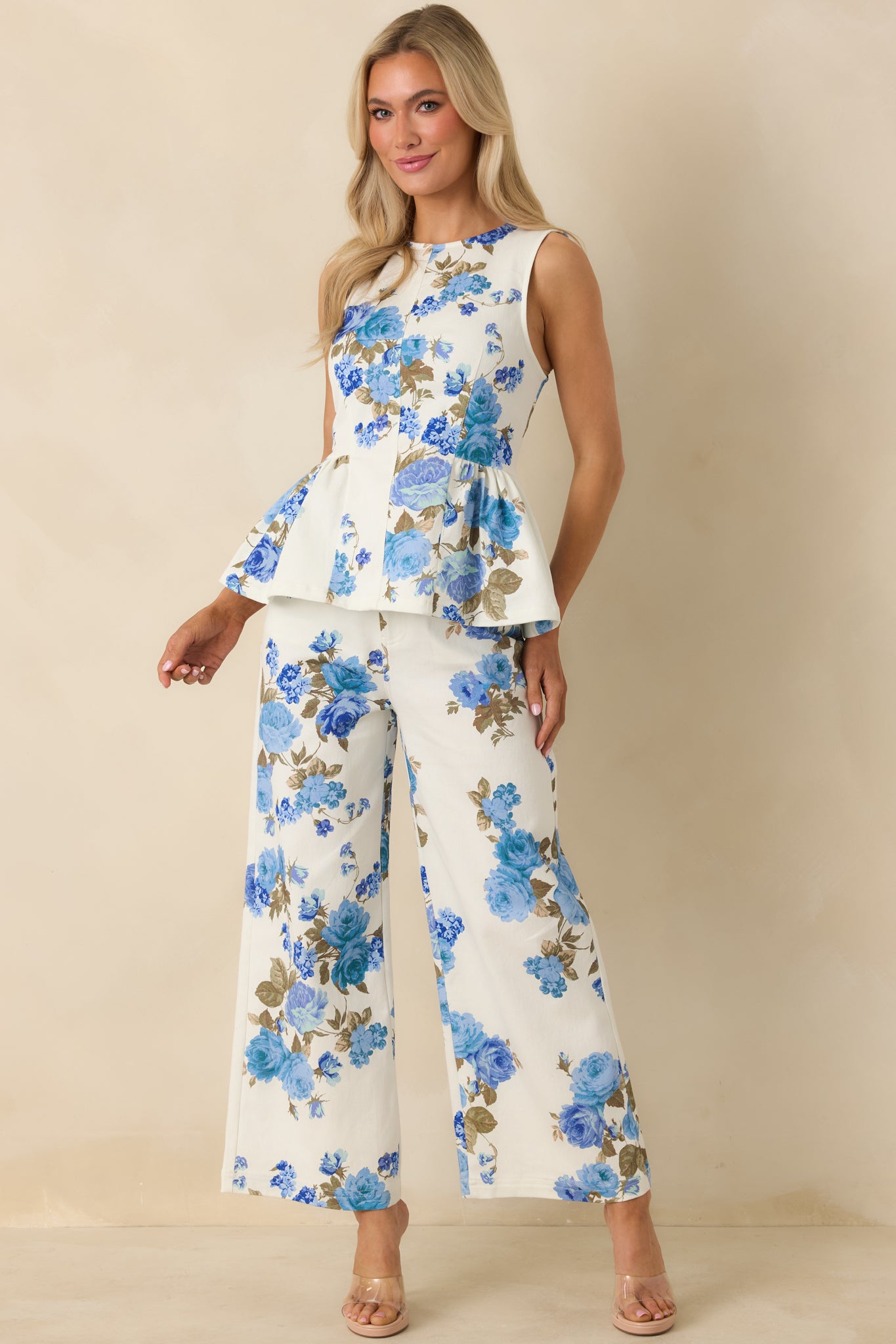 High-waist cotton pants featuring a wide-leg cut, belt loops, and allover blue floral pattern.
