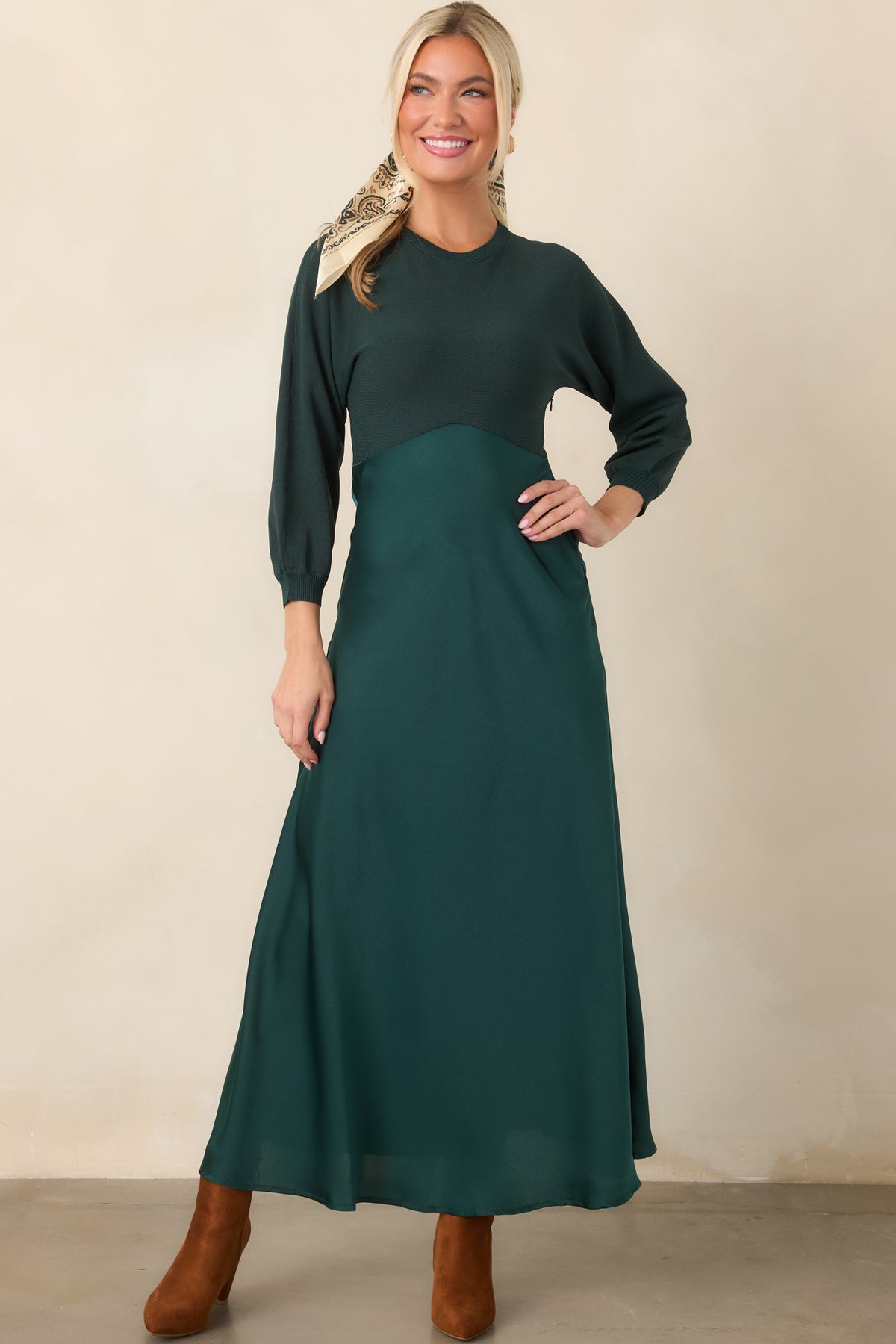 High-waisted satin skirt flows from the fitted emerald knit bodice of this coordinated midi-length dress.