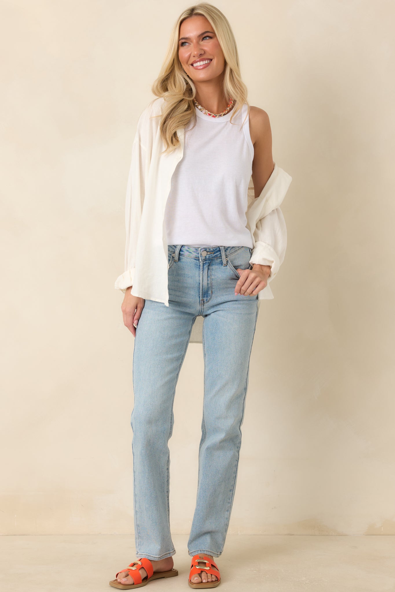 High waisted straight leg jeans featuring a structured silhouette, classic denim design, and functional pockets.