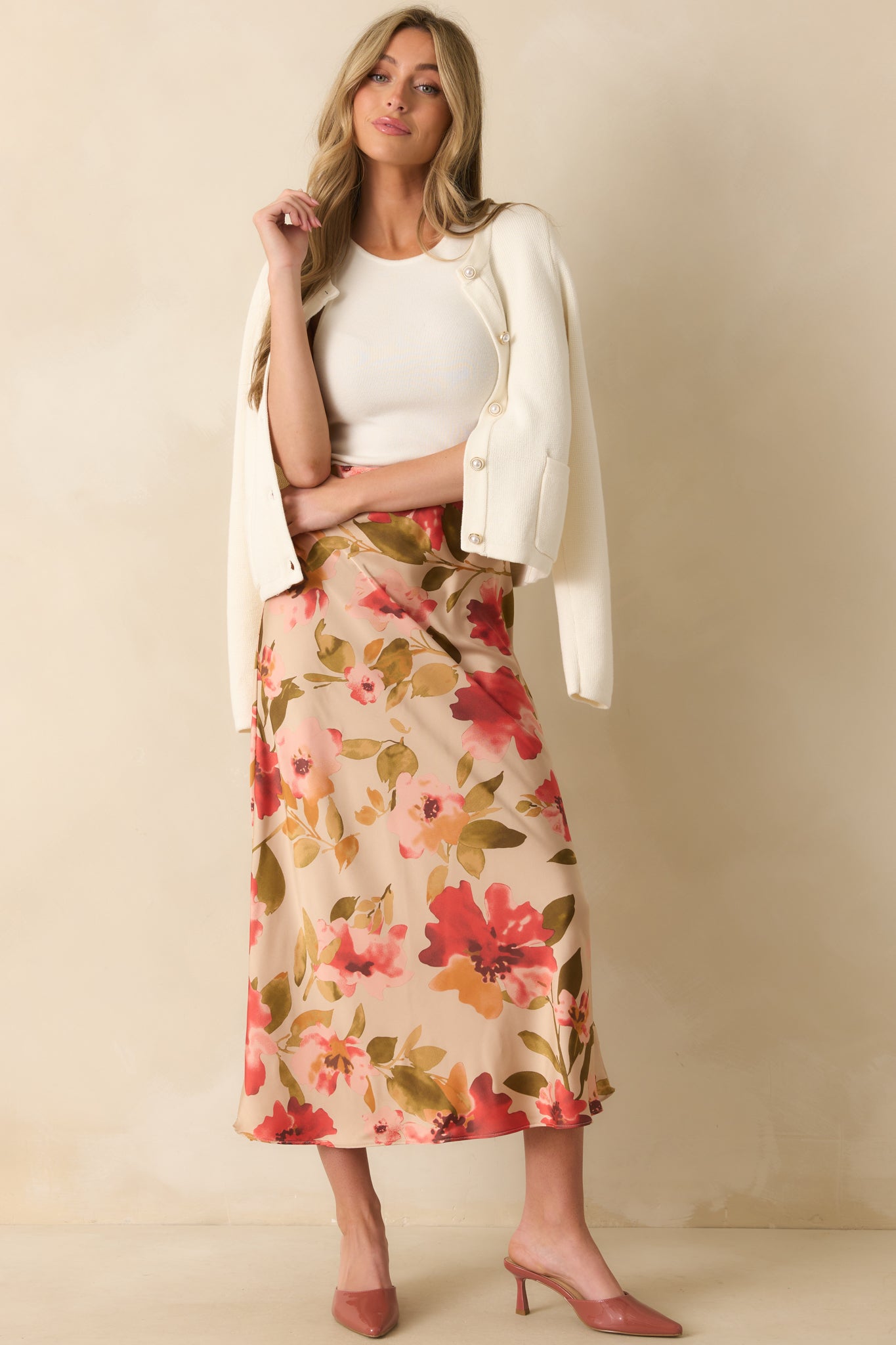 High-waisted tan maxi skirt with subtle pleating and multicolor pink floral design.