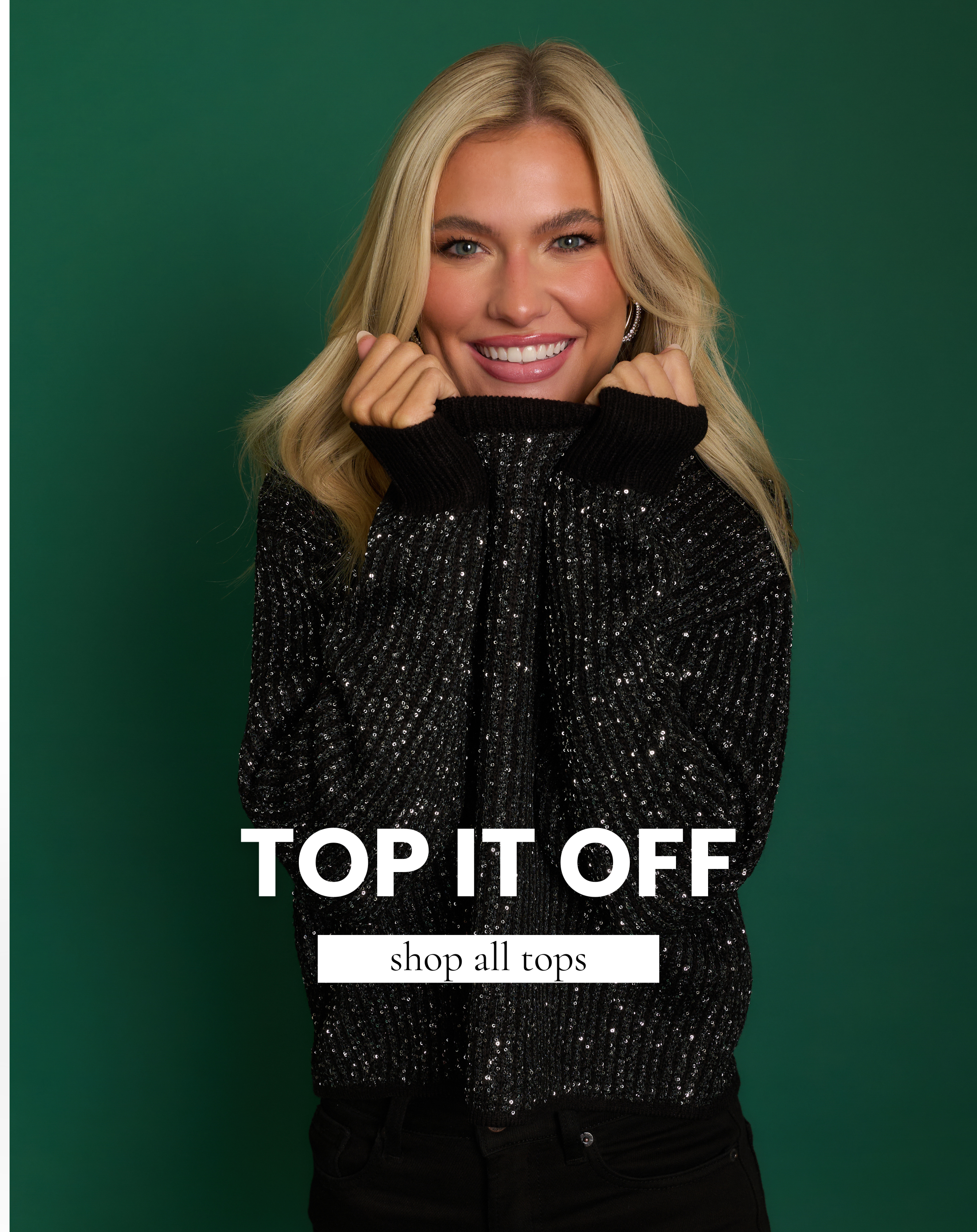 Smiling model wearing a black sequin knit sweater poses against a green background. Shop chic women’s holiday tops and sparkly sweaters for the season.