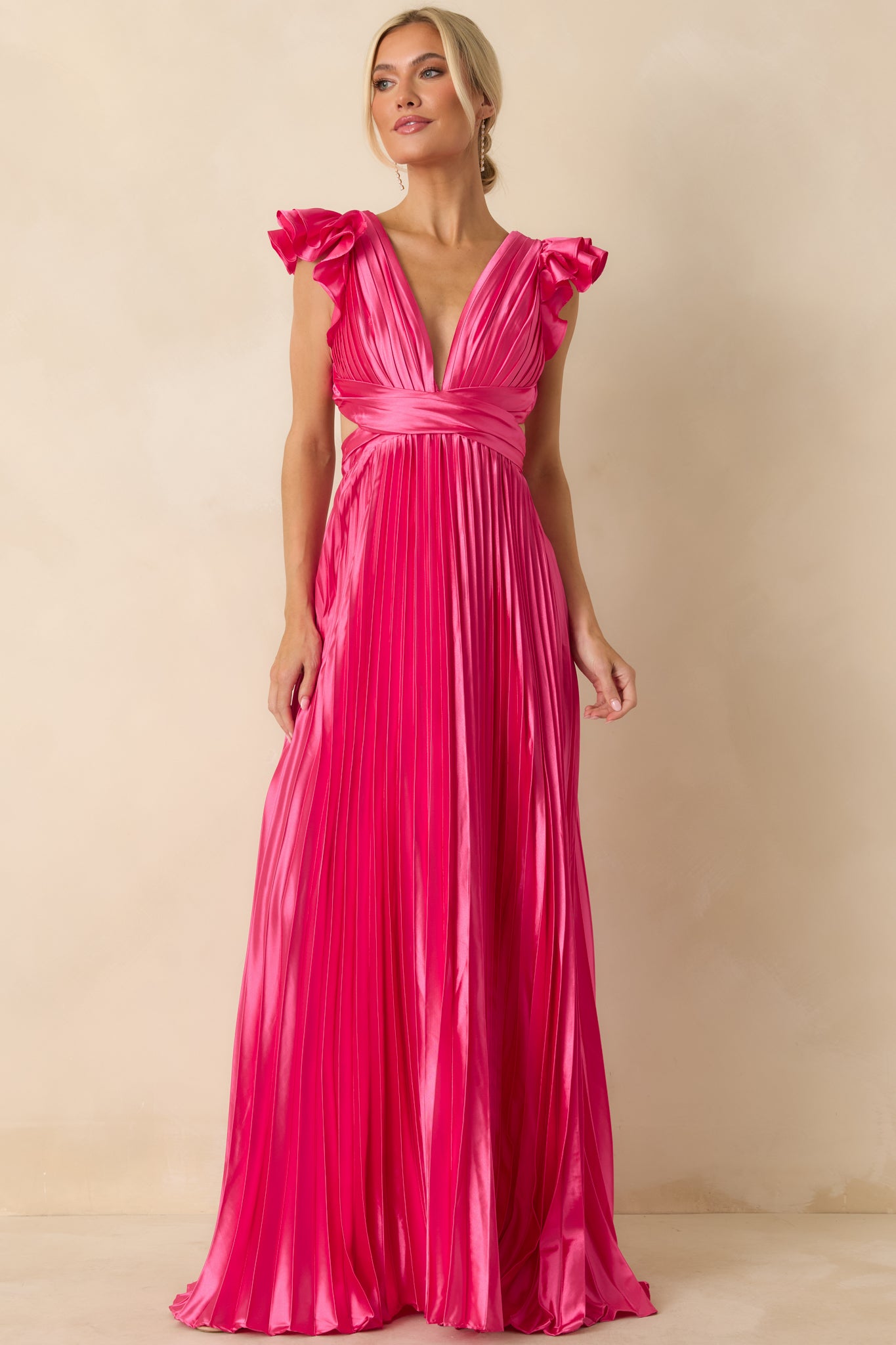 Hot pink maxi dress showcasing silky woven fabric, ruffled cap sleeves, and pleated A-line skirt.