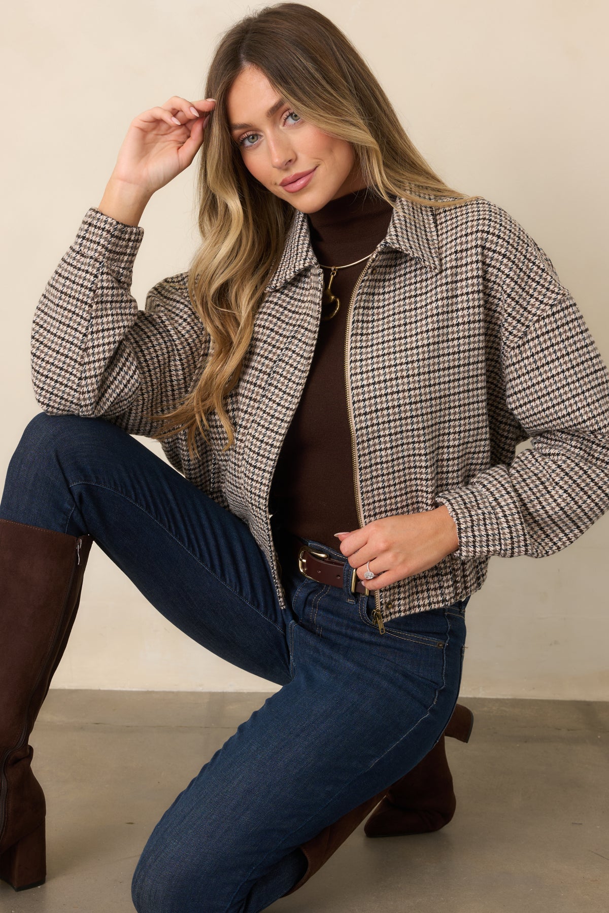 Full-length front zipper and functional pockets complement the cropped silhouette of this houndstooth jacket.