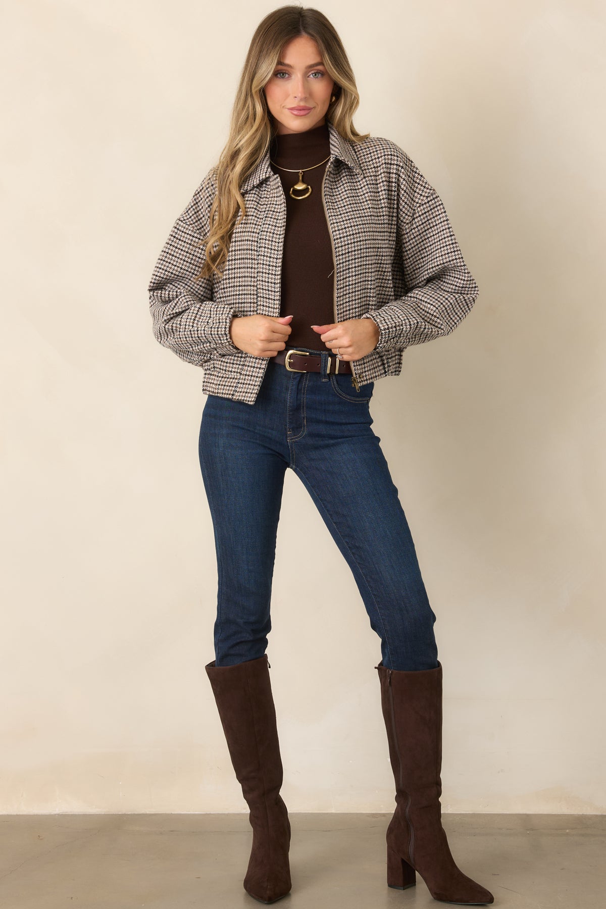 Houndstooth woven jacket with an oversized fit, spread collar, full-length zipper, cropped hem, and functional pockets.