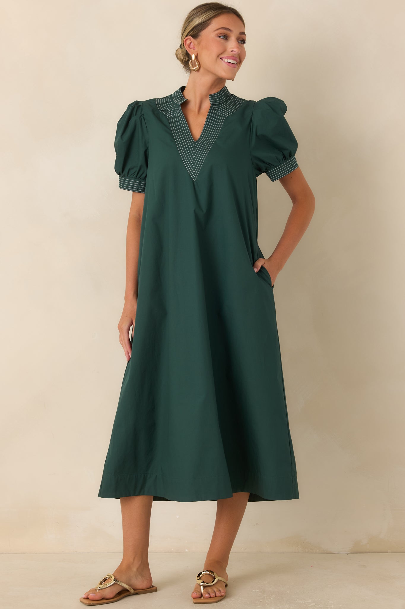 Hunter green A-line dress featuring short puff sleeves, dimensional stitching, and a relaxed fit.