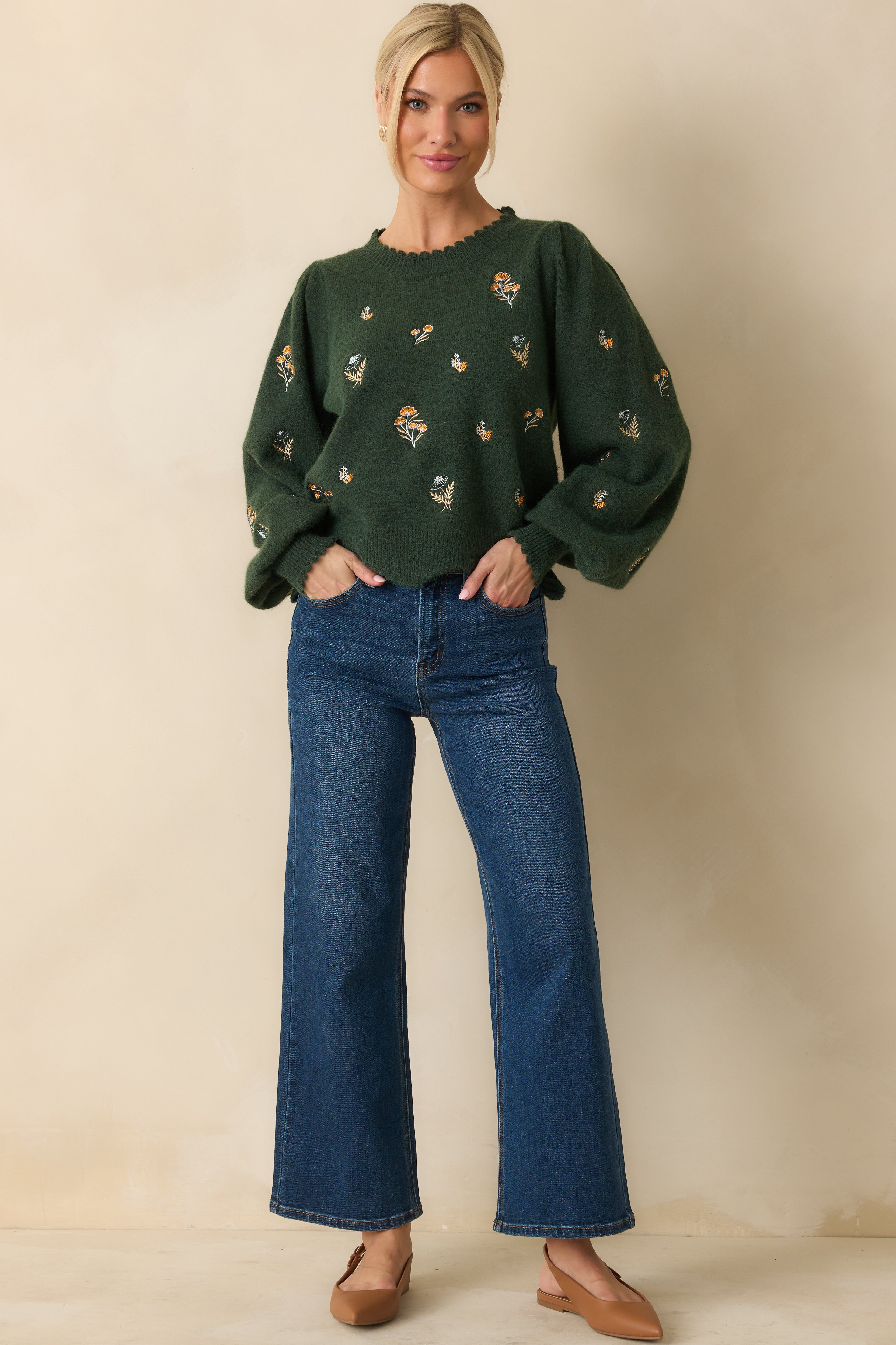 Hunter green knit sweater with embroidered floral detailing and a relaxed fit.