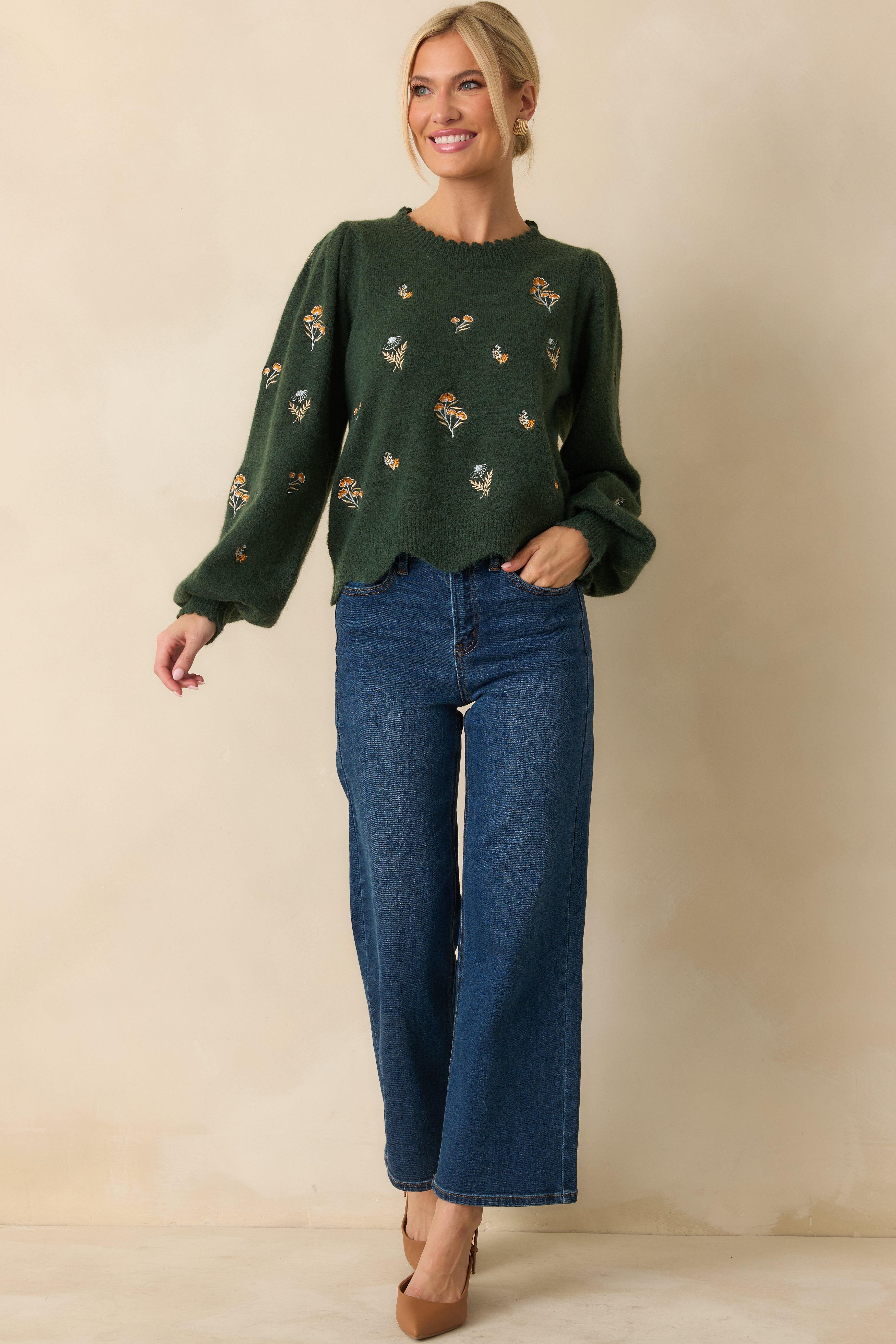 Cozy hunter green sweater with ribbed cuffs and intricate embroidered accents.