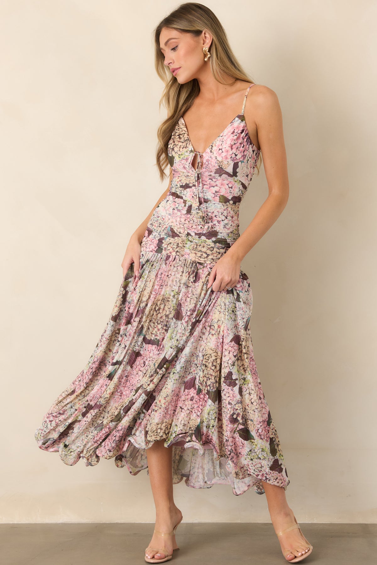 Hydrangea-inspired floral print maxi dress featuring adjustable spaghetti straps, a V-neckline with front tie, ruched bodice, gathered skirt, and wavy hemline.