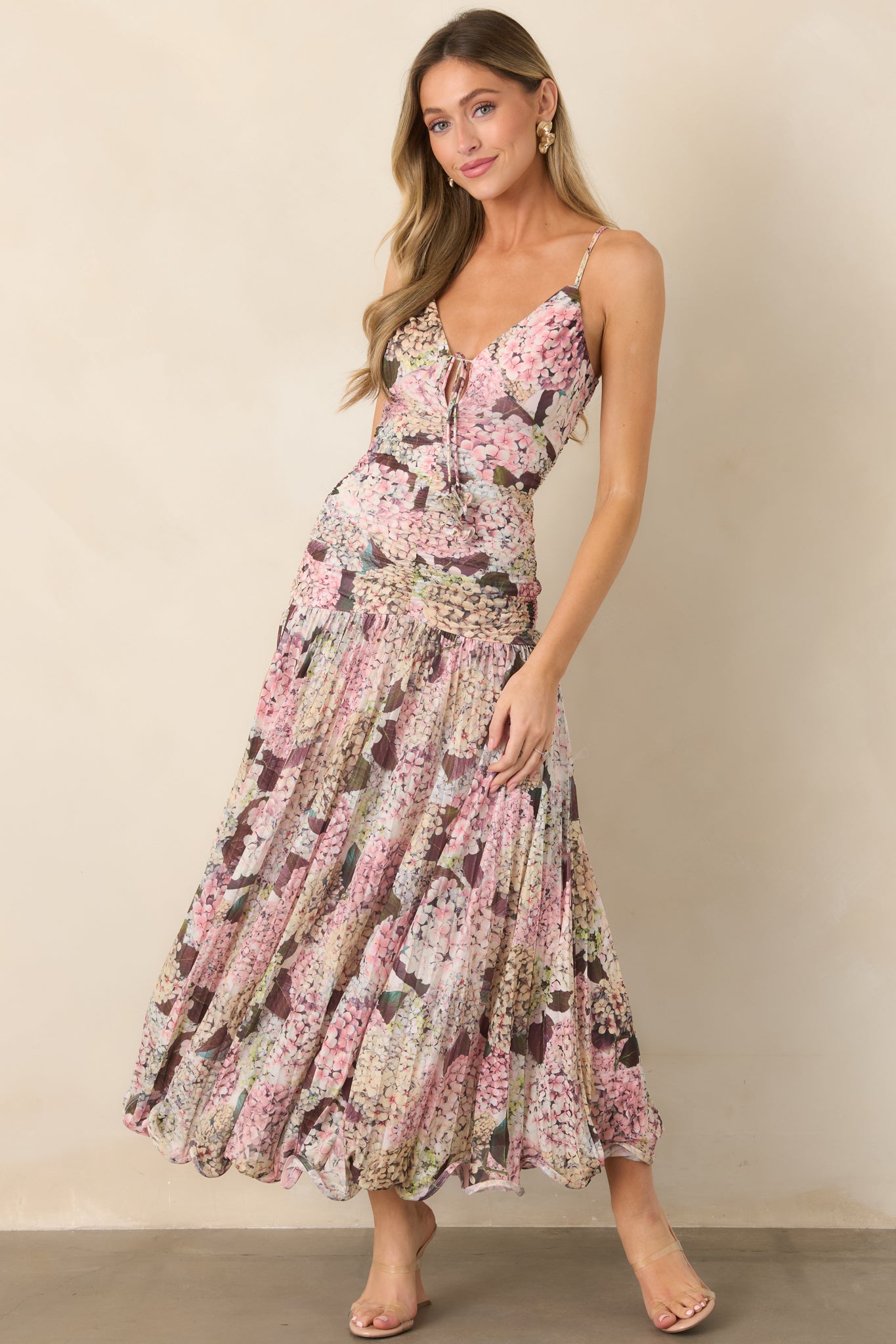 Dreamy hydrangea-print maxi dress with a shaped waist, adjustable spaghetti straps, softly gathered skirt, and distinctive wavy hemline.