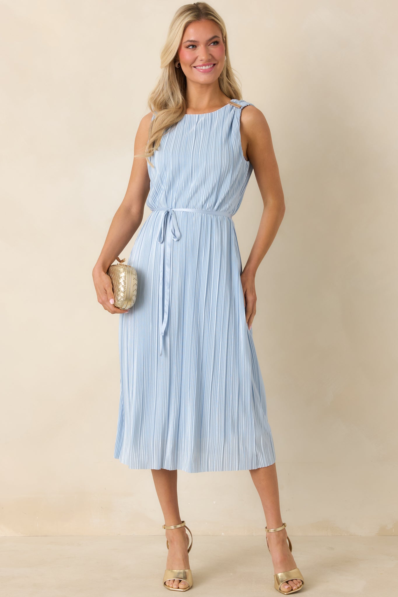 Front-facing image emphasizing the minimalist silhouette and midi-length movement.