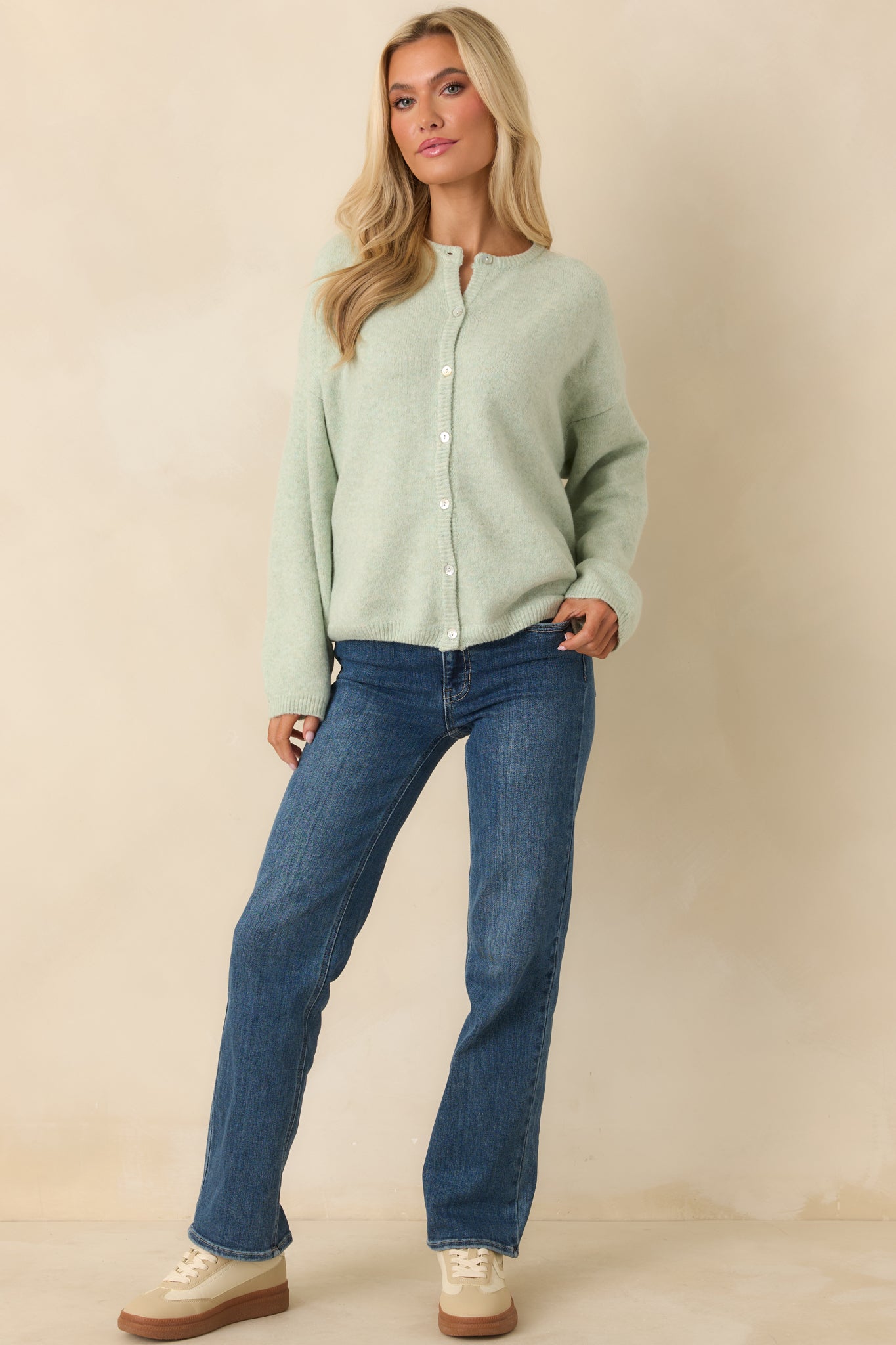 Front-facing full body image emphasizing the ribbed trim at the neckline, cuffs, and hem.