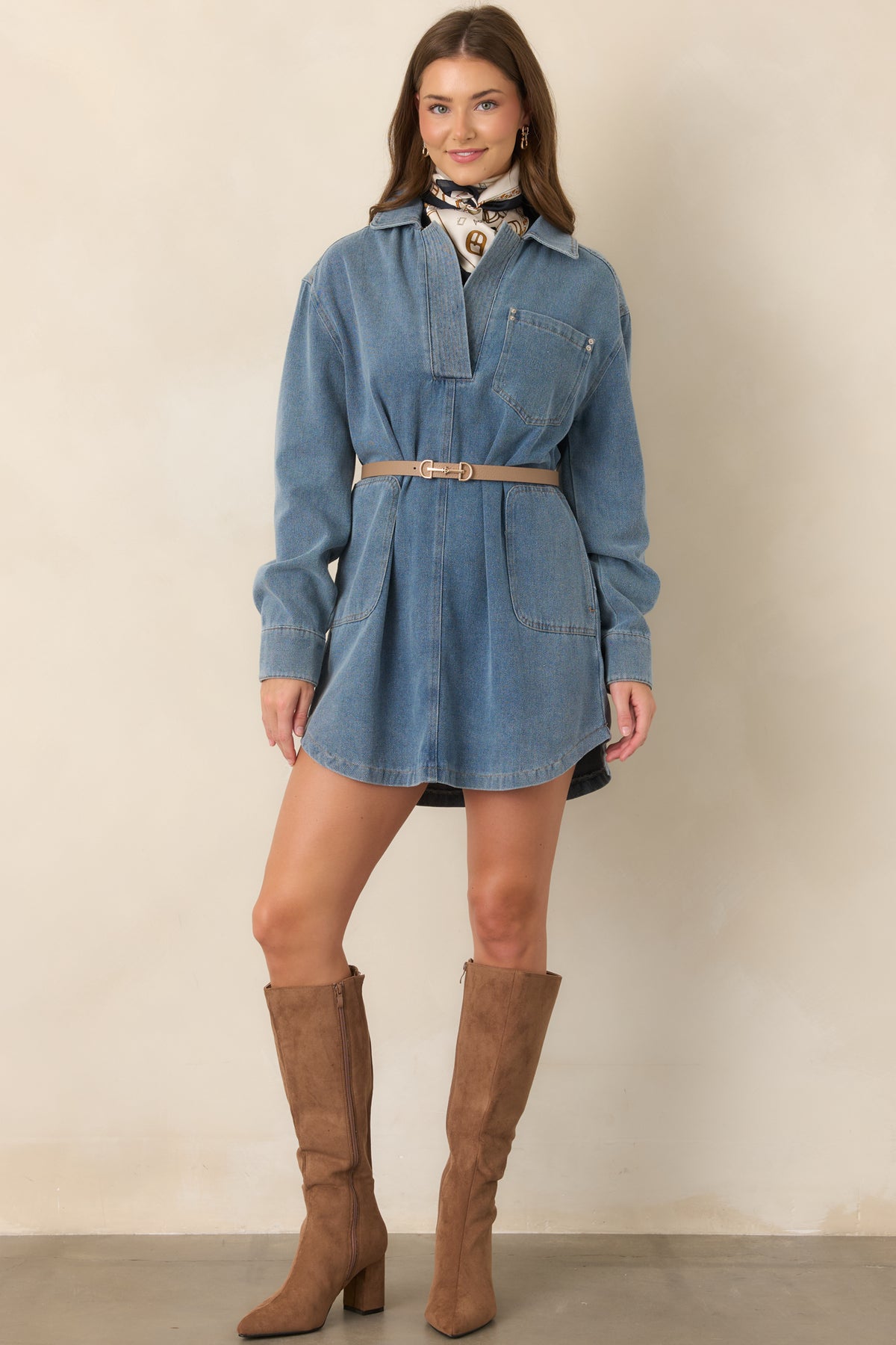 Structured indigo denim dress with a slightly oversized silhouette, long sleeves, front patch pockets, button-front placket, and crisp straight hemline.
