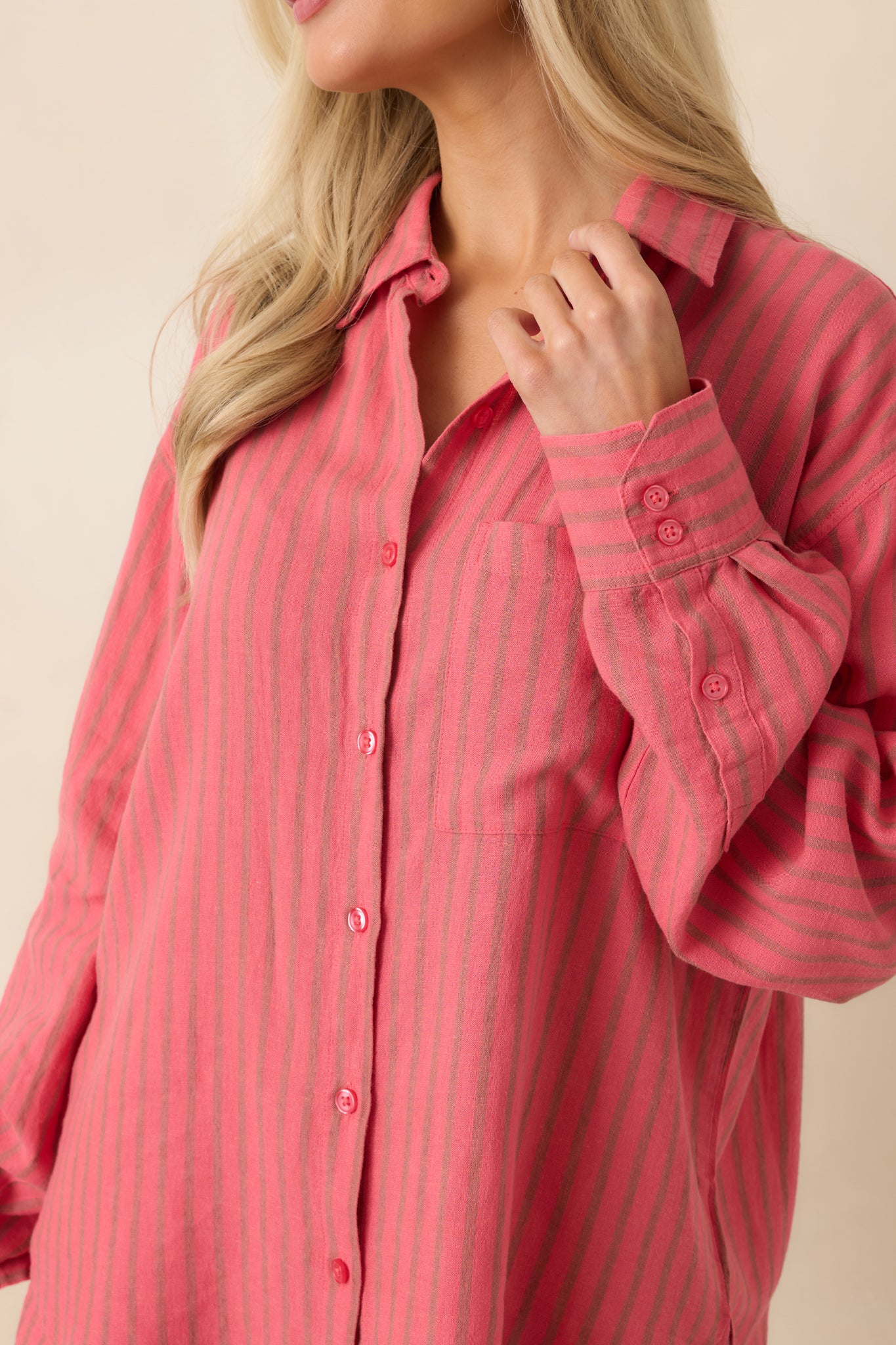 Detailed view of indigo stripe pattern, button front closure, and chest pocket stitching.