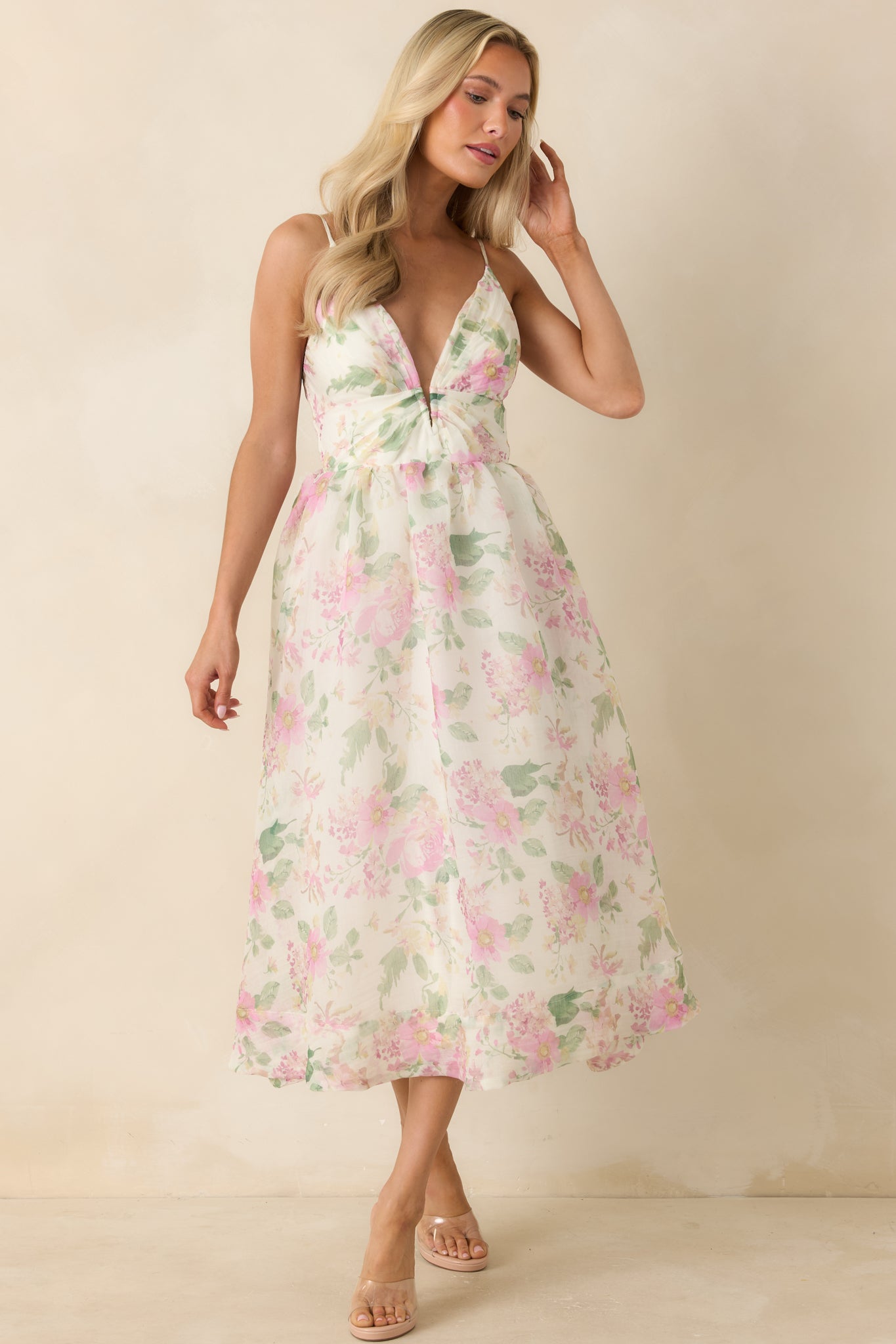 Ivory and pink dress featuring a deep V-neckline and a feminine, relaxed fit designed for movement.