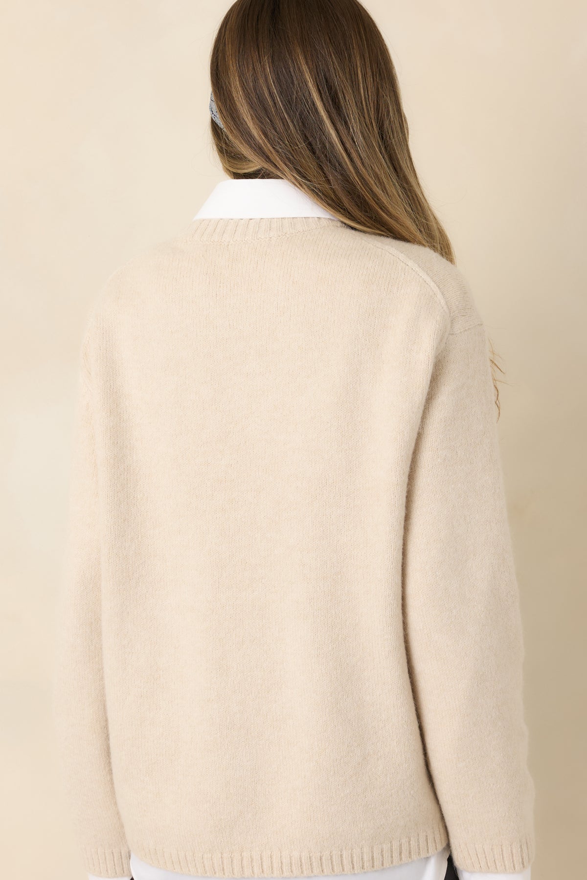 Plain ivory-beige fuzzy knit back with dropped shoulders, roomy long sleeves, and ribbed hem.