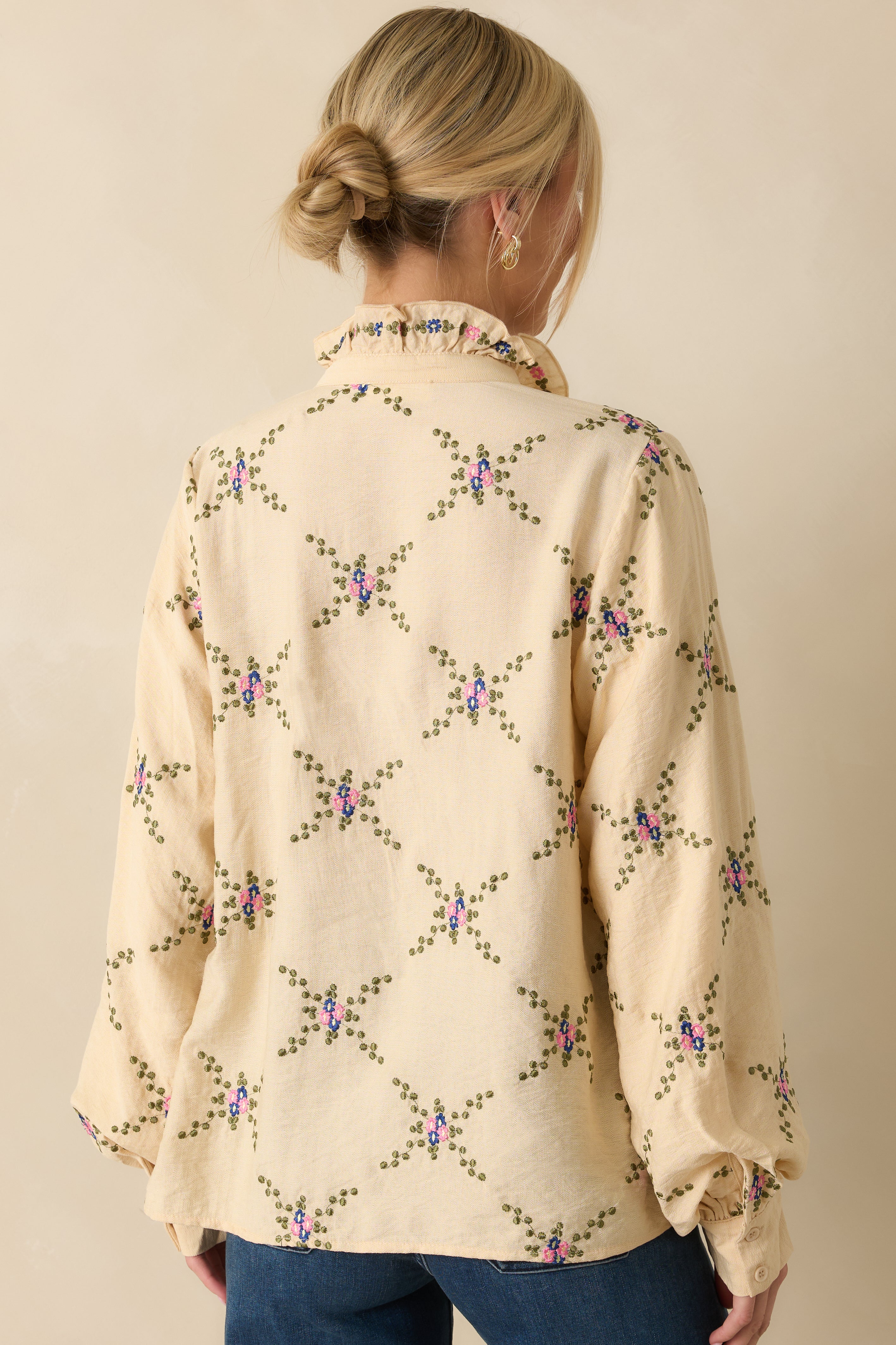 Rear view of the ivory blouse showing long balloon sleeves and relaxed fit.