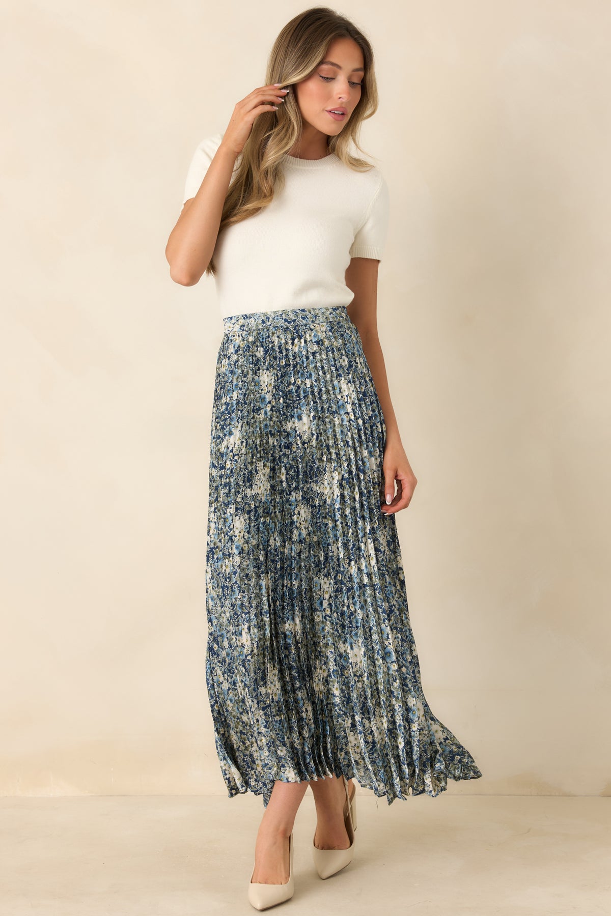Flowing maxi skirt featuring delicate ivory and blue florals against a deep blue background.
