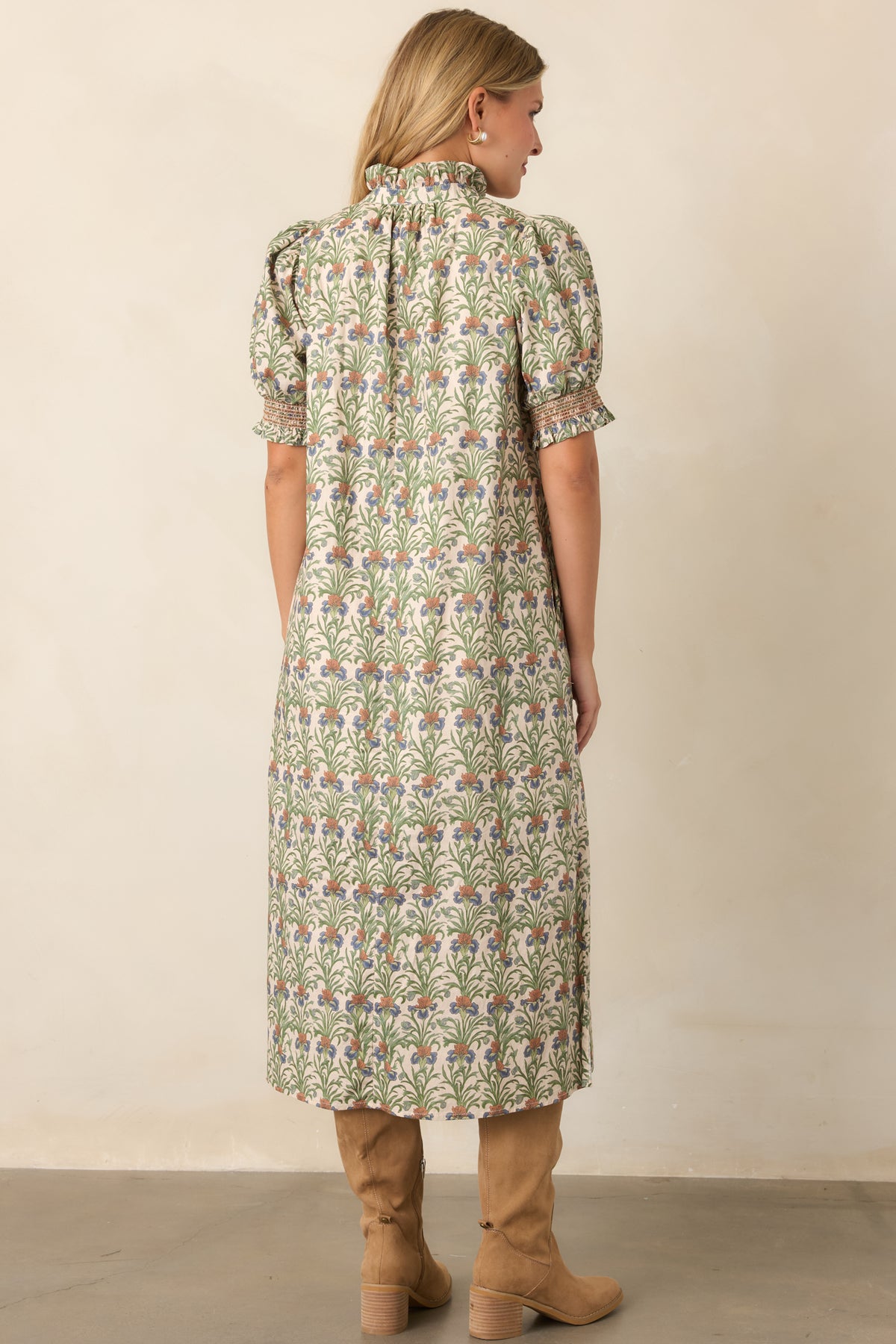 Rear of the ivory botanical cotton dress showing its relaxed A-line silhouette and flowing shape.