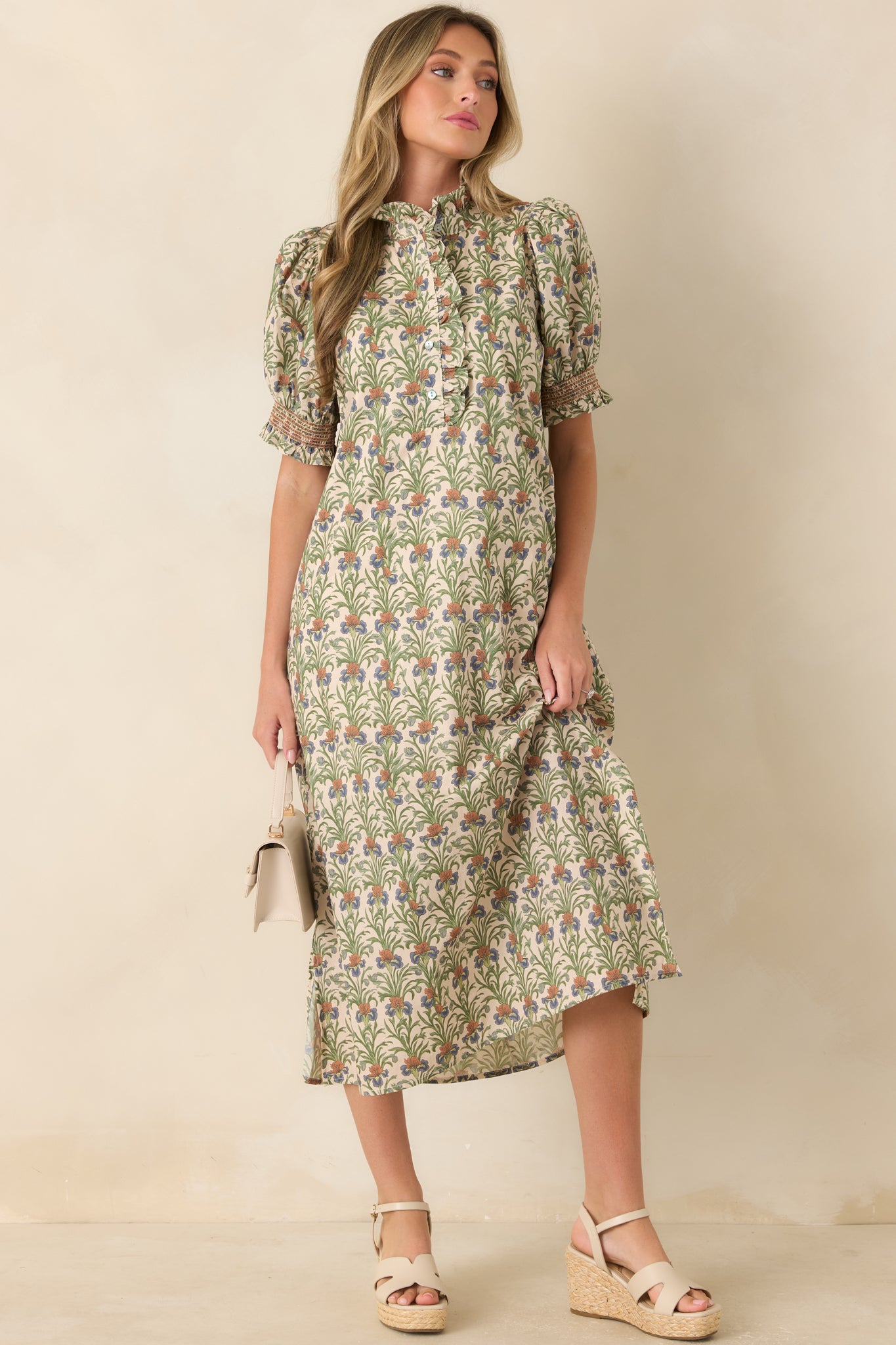 Ivory cotton midi dress featuring a mossy green botanical print, ruffled stand collar, puff sleeves, and a relaxed A-line silhouette.
