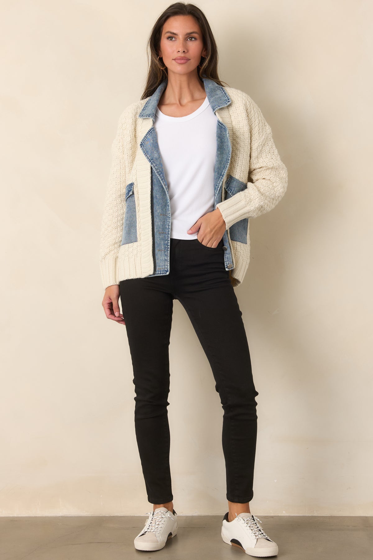 Ivory chunky knit jacket featuring a contrasting denim collar, placket, and flap pockets.