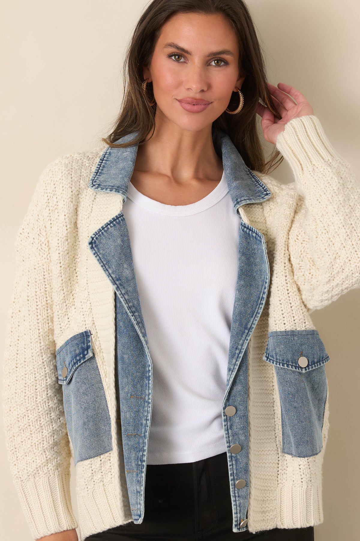  Chunky ivory knit texture contrasts with the jacket's structured denim collar.