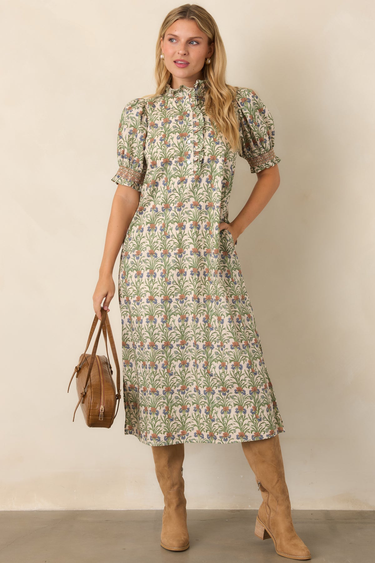 Ivory cotton dress featuring a mossy green botanical print, ruffled stand collar, and relaxed A-line silhouette.