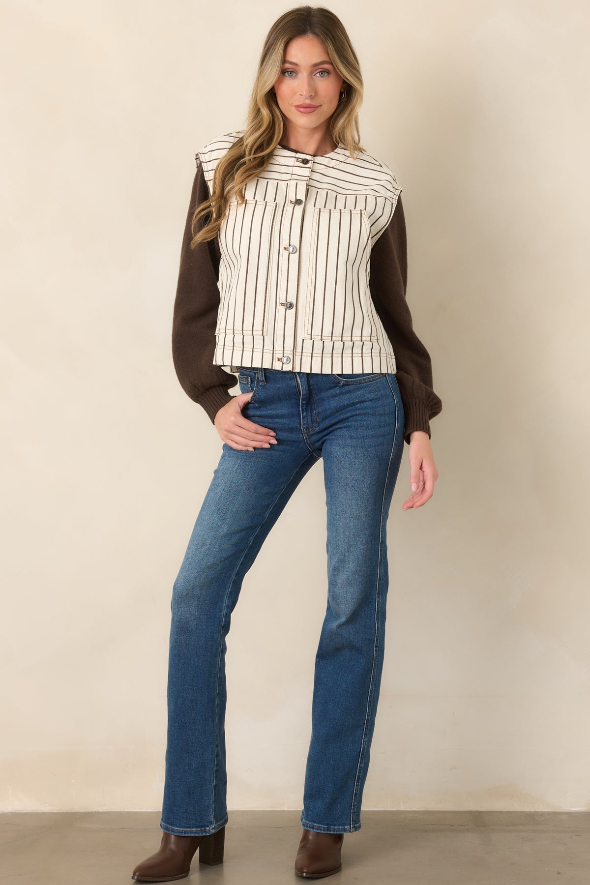 Structured ivory cotton vest featuring brown pinstripes, a clean round neckline, contrasting horizontal yoke, and mixed metal buttons.