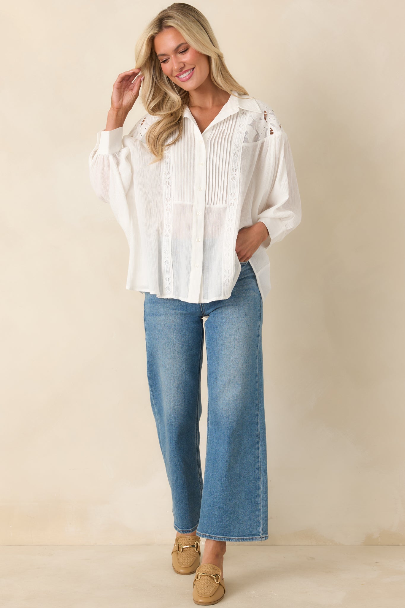 Ivory cotton button-down top with gauze texture and relaxed batwing sleeves.