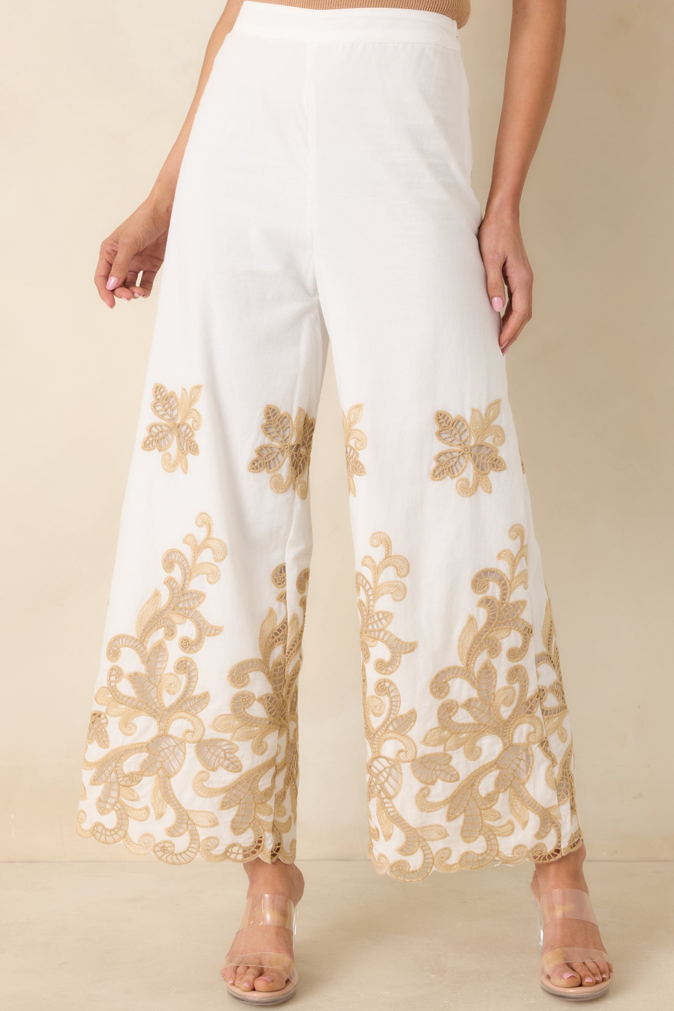 Ivory cotton fabric highlighting scalloped hem and soft structure.