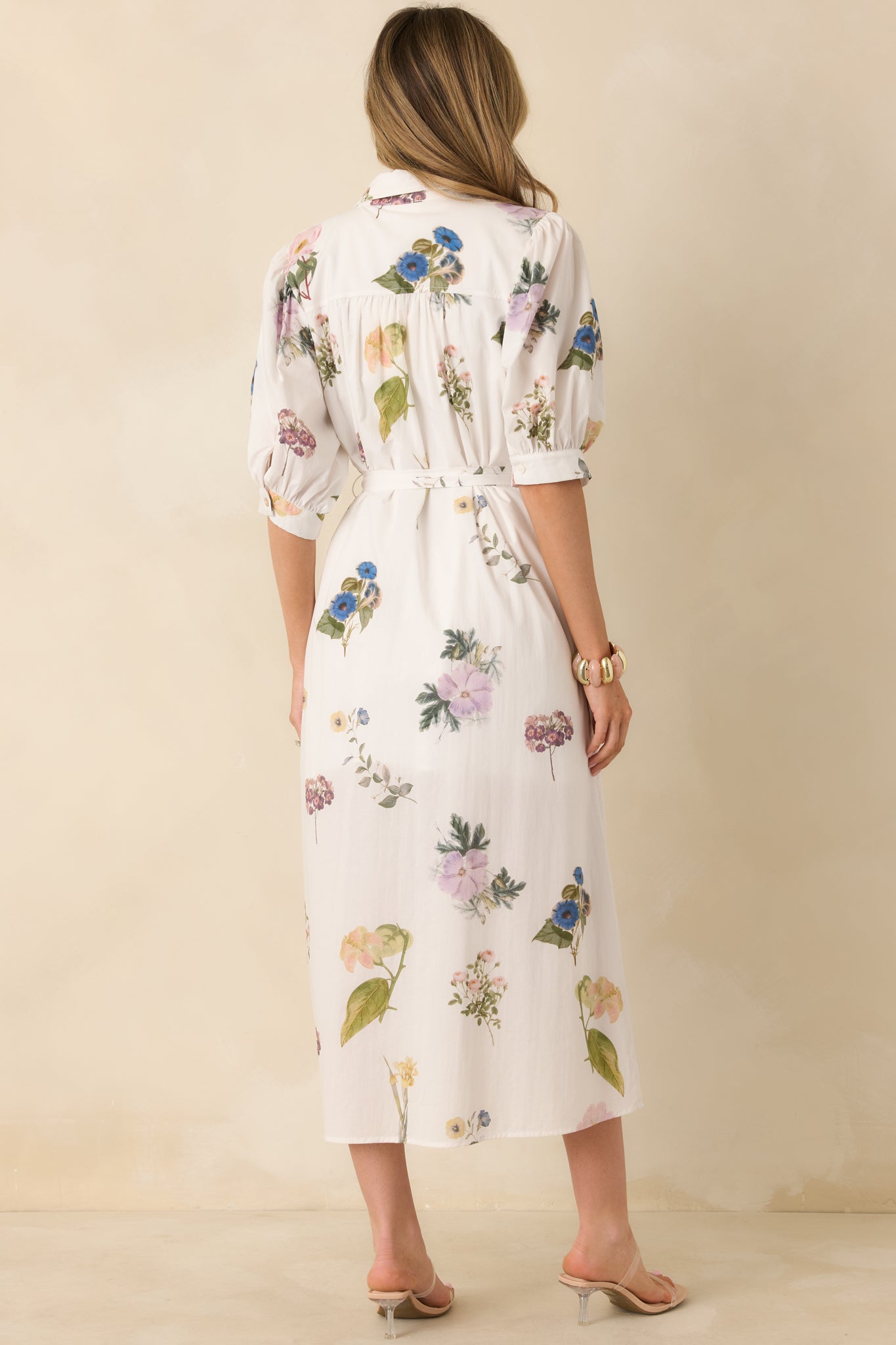 Ivory cotton floral midi dress with the multicolor print extending across the rear silhouette.