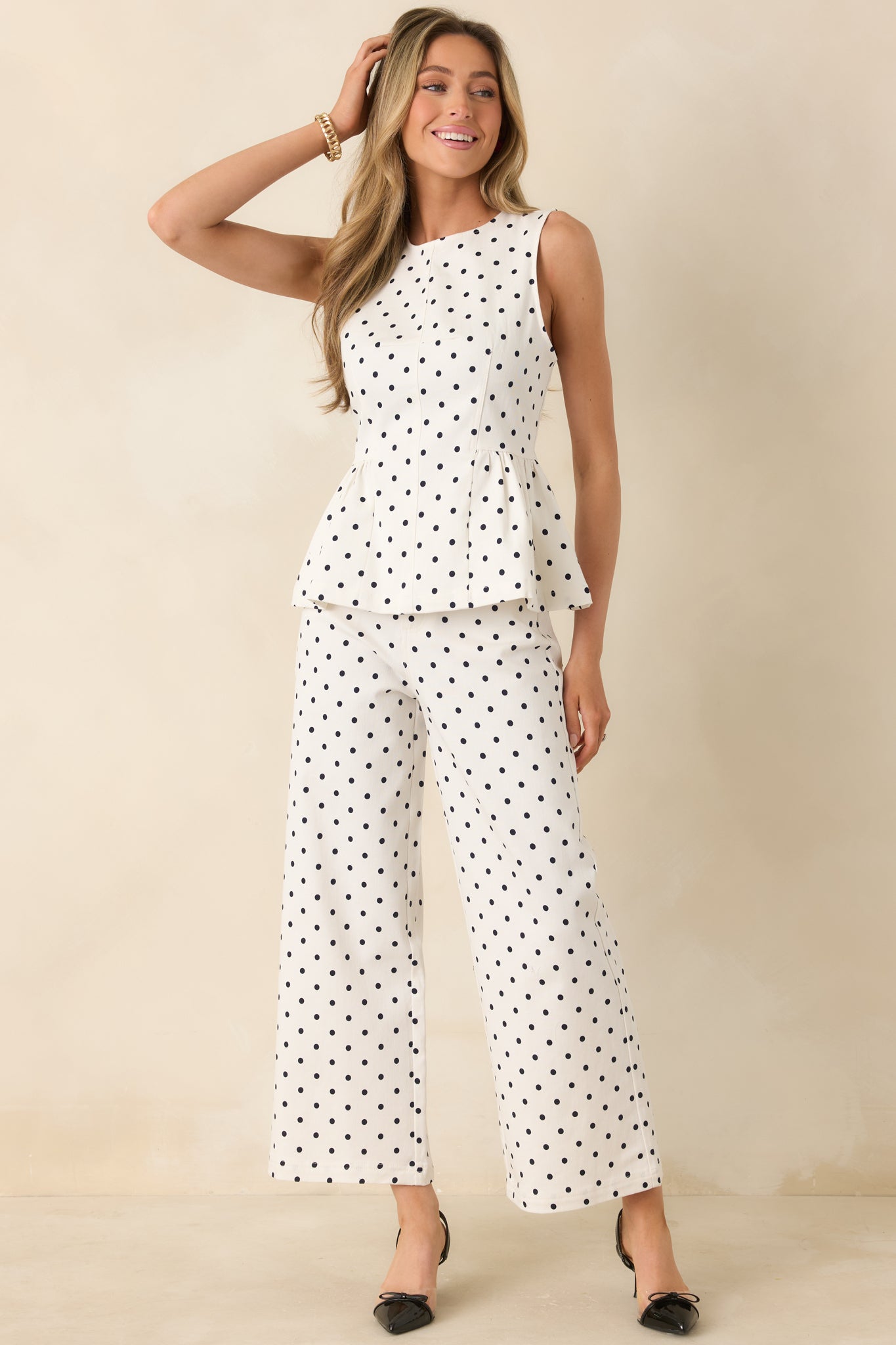 Ivory cotton pants with black polka dot print, high-rise waist, and straight leg silhouette.