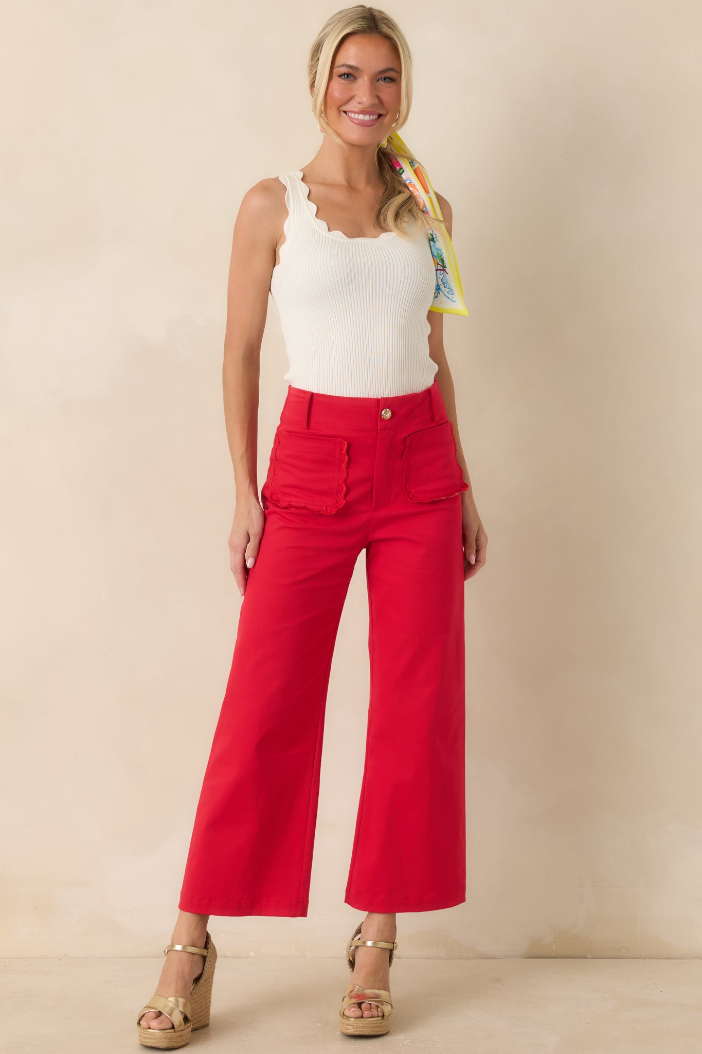 Cotton tank featuring a classic scoop neckline, feminine scalloped hems, and a comfortable fitted shape.