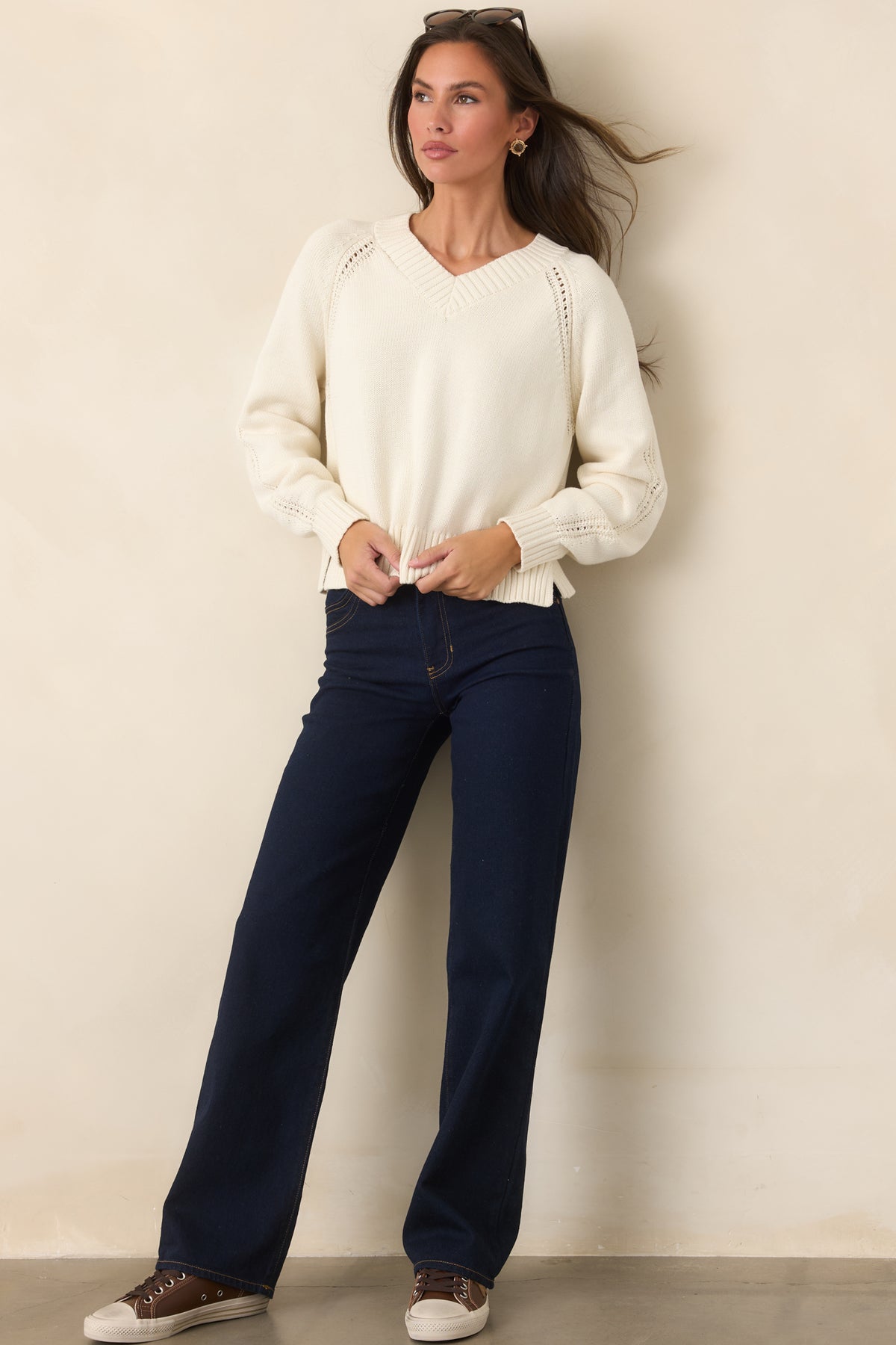 Ivory cotton top features a relaxed silhouette with a ribbed V-neckline and coordinating ribbed trim along the cuffs and hem.