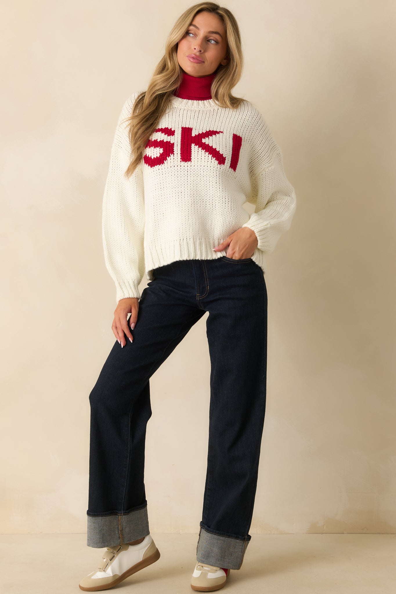 Full-length image of ivory crew-neck sweater highlighting soft midweight yarn texture.