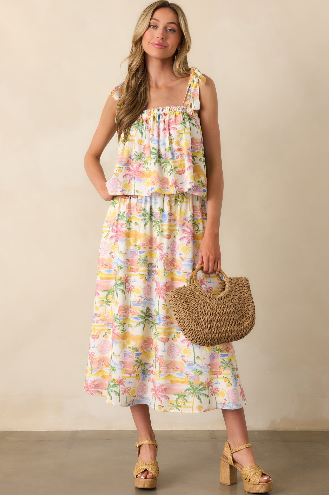 Full view of an ivory cropped top with a multicolor tropical print, featuring a square neckline and flowy fit.