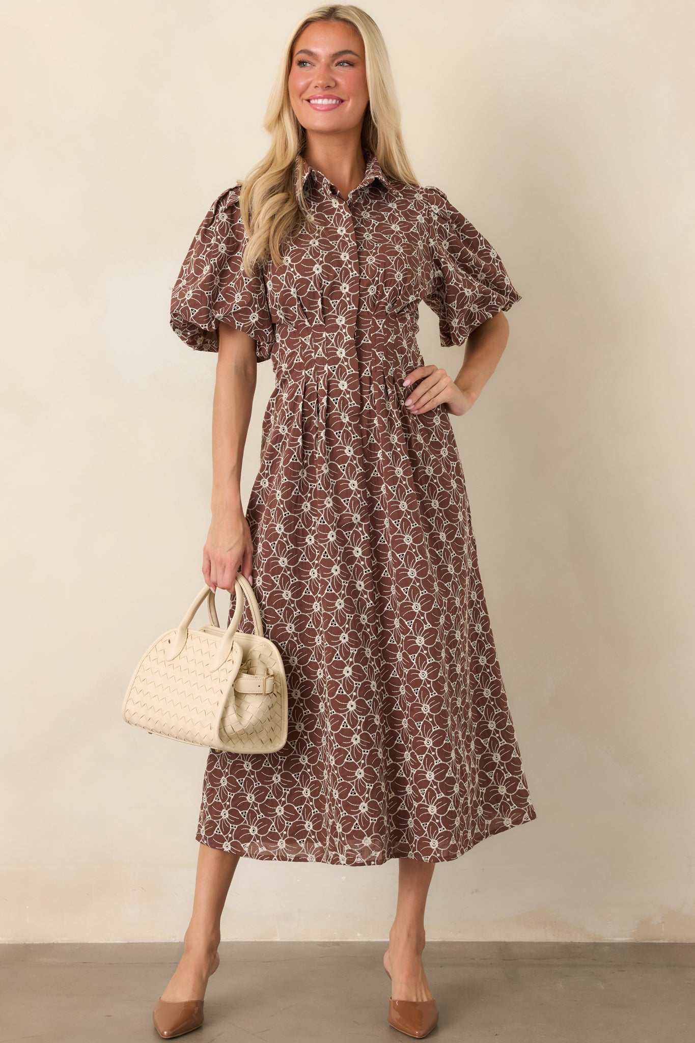 Ivory embroidered dress showcasing a classic collared bodice, button-front design, fitted waistline, and voluminous midi skirt.