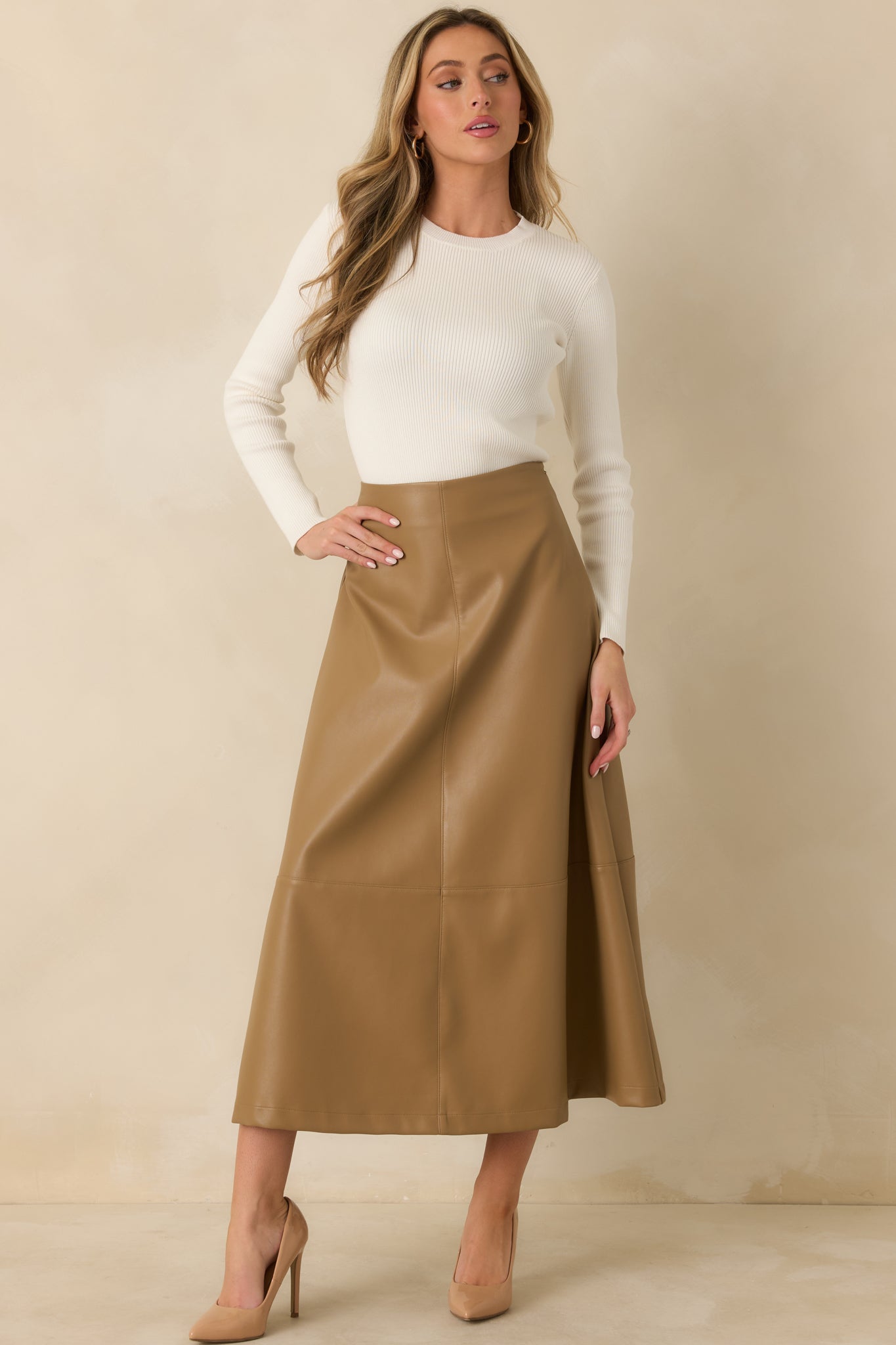 Fitted ivory long sleeve top crafted from finely ribbed cotton knit with a clean crew neckline.