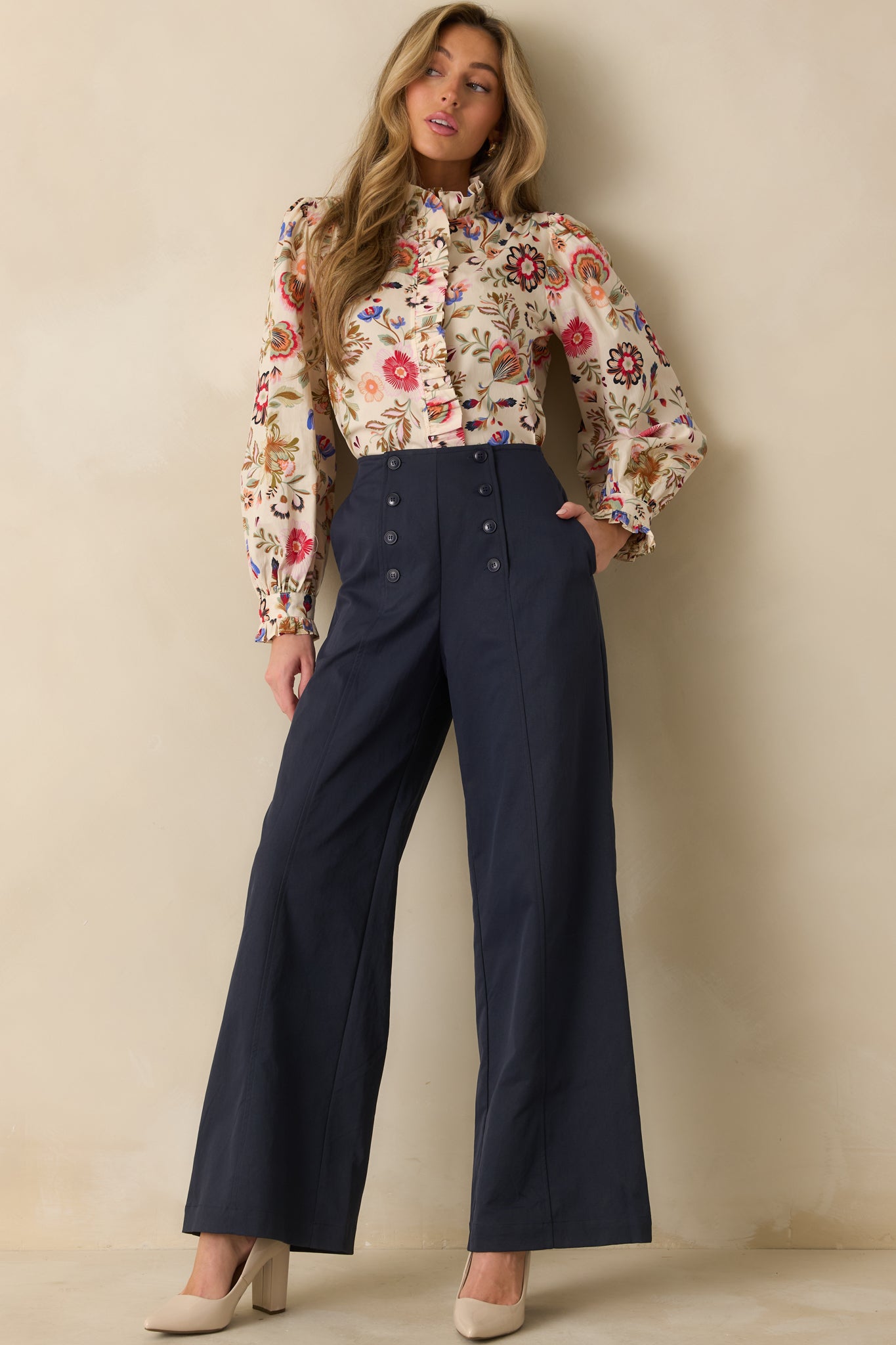 Ivory floral button-up top showing relaxed fit and subtle feminine details in the sleeves and neckline.
